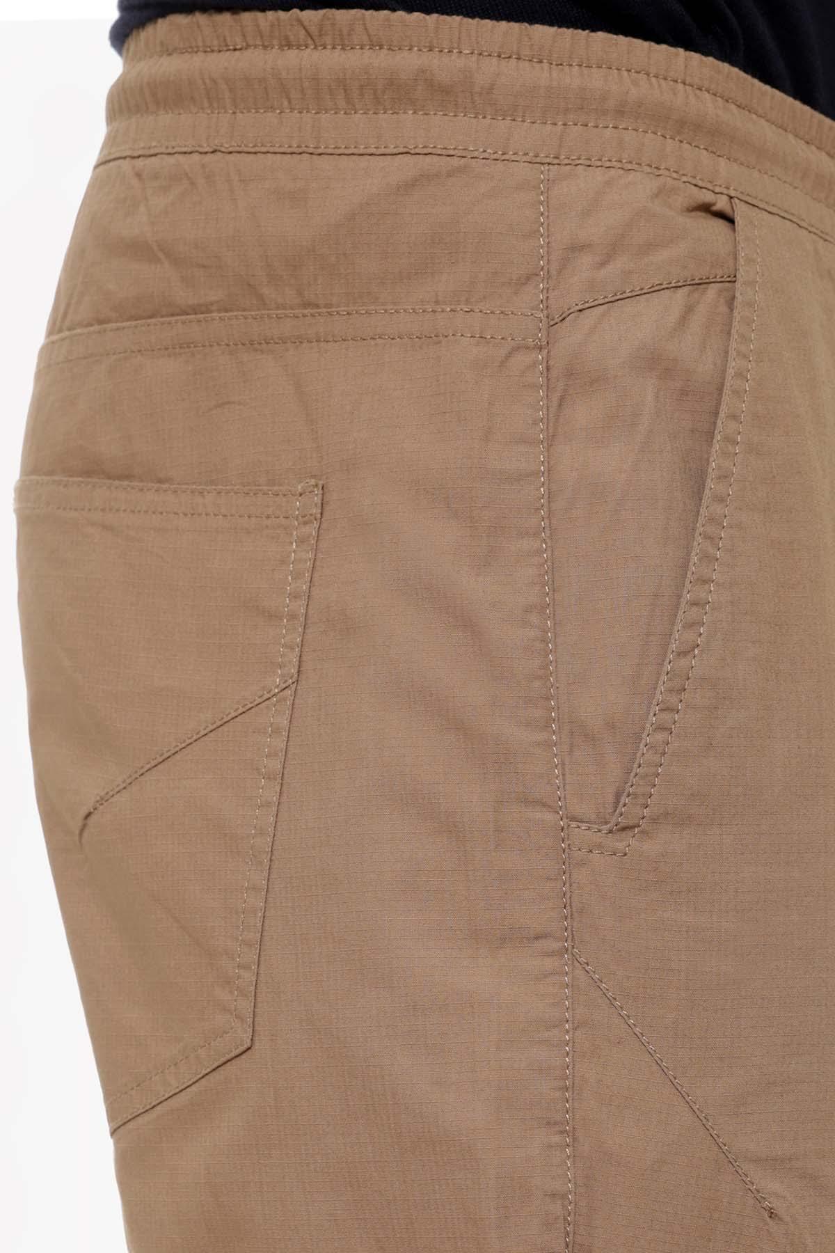 Dark khaki casual trouser close-up: side pocket, seam details, and drawstring waist