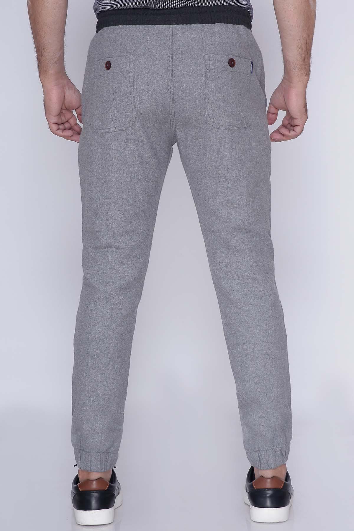 Grey casual trousers back view with buttoned back pockets and cuffed hems