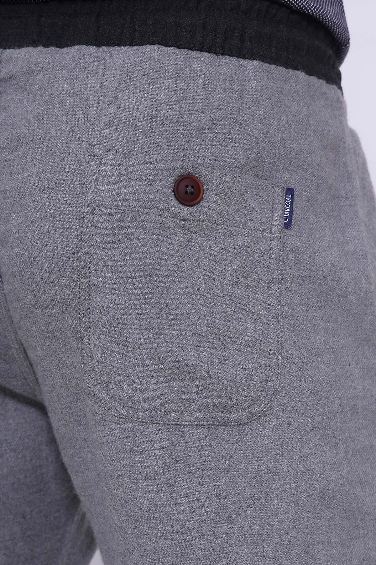 Grey casual trousers close-up of side pocket and brown button on waistband