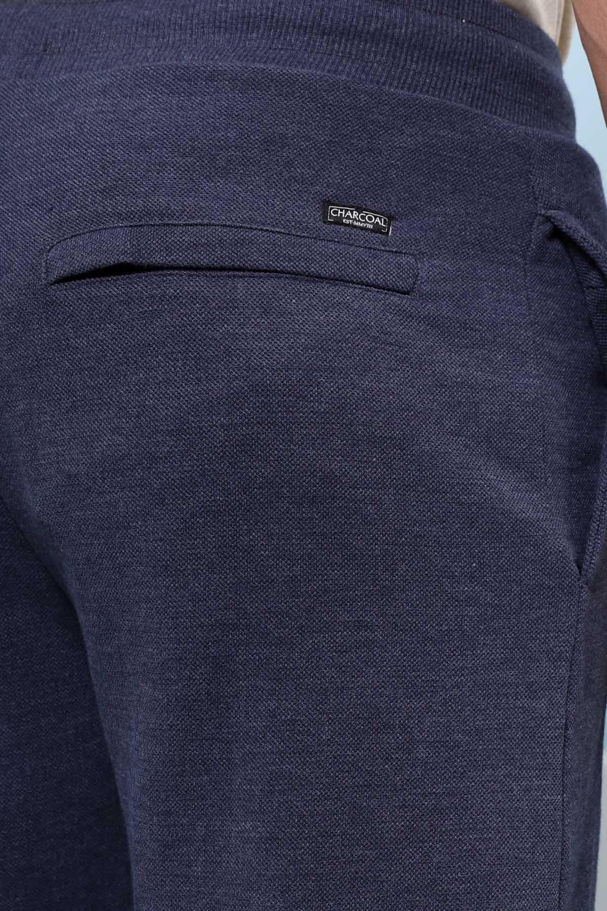 Indigo trouser fabric with side pocket seam and stitched brand label