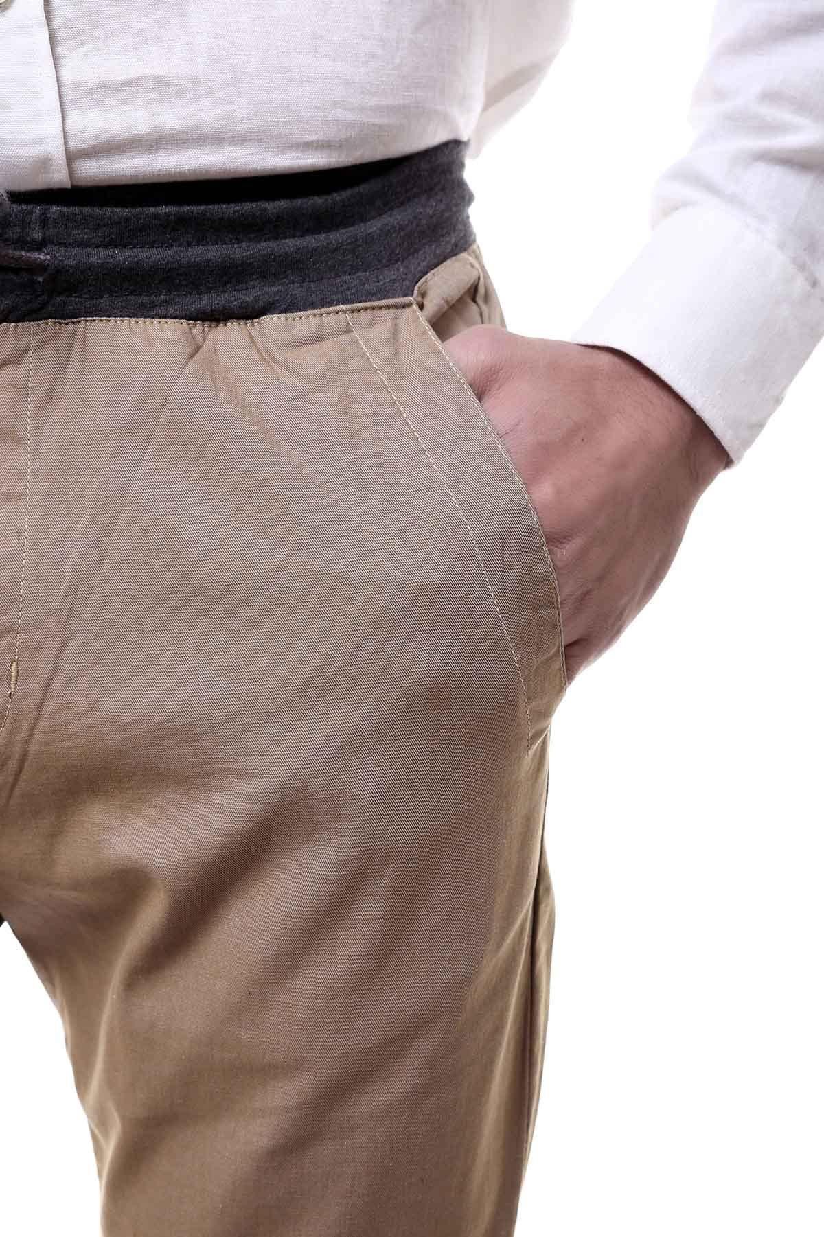 Khaki casual trouser with elastic waistband and button fly detail, side view