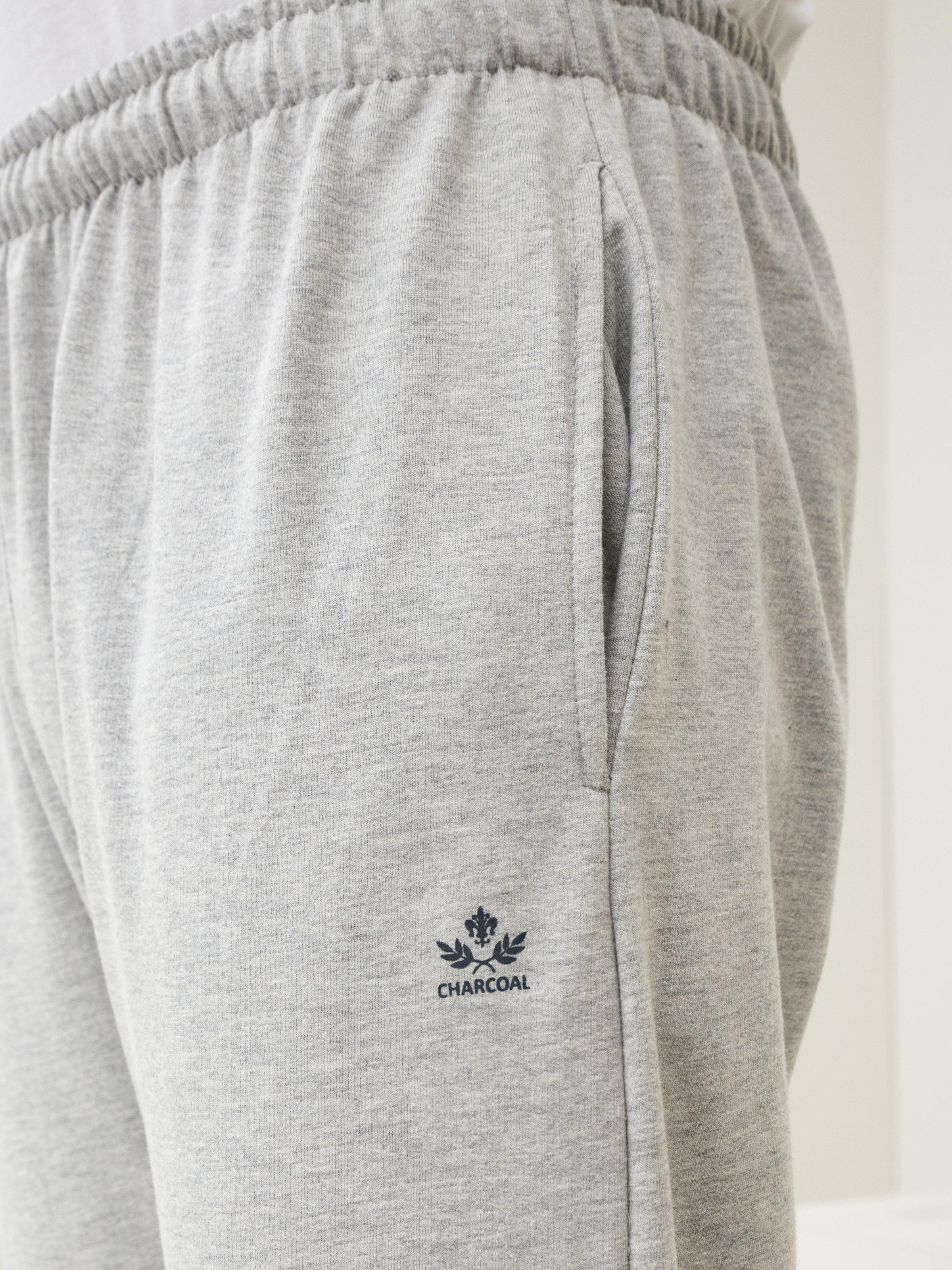 Grey melange knit trouser waistband with drawstring and logo patch on side