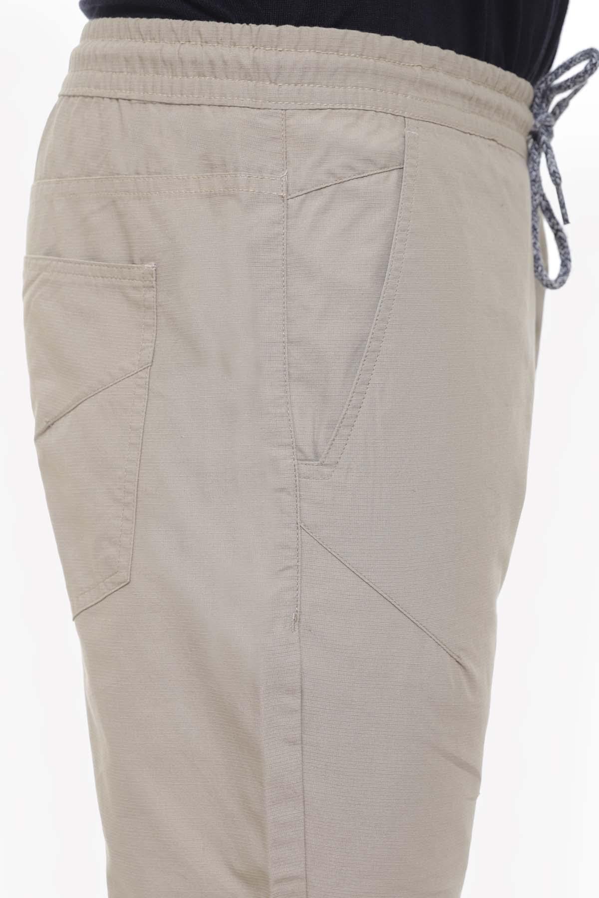 Light khaki casual trousers close-up of drawstring waistband and side pockets