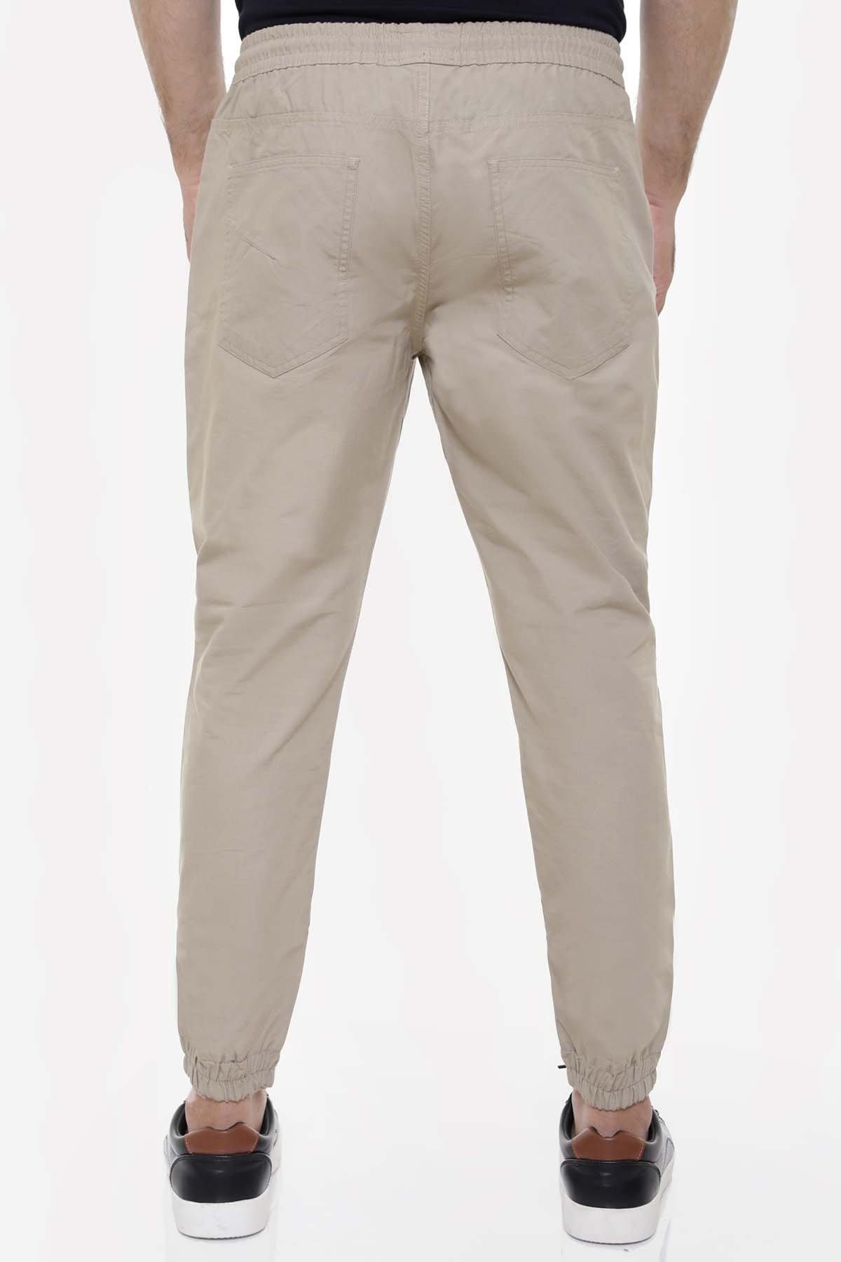 Light khaki casual trousers, back view, with hip pockets and tapered cuffs
