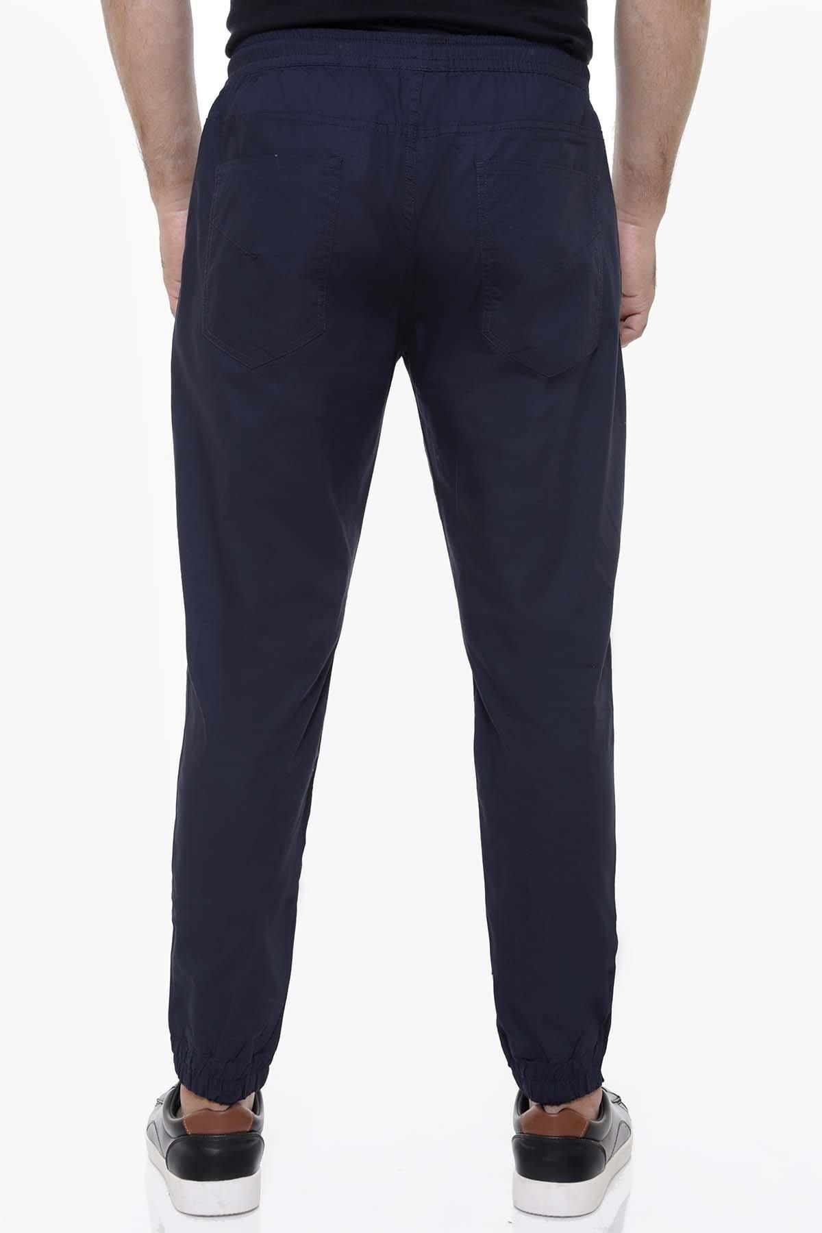 Navy casual trousers with elastic waistband, slim leg, and ankle-length cuffs