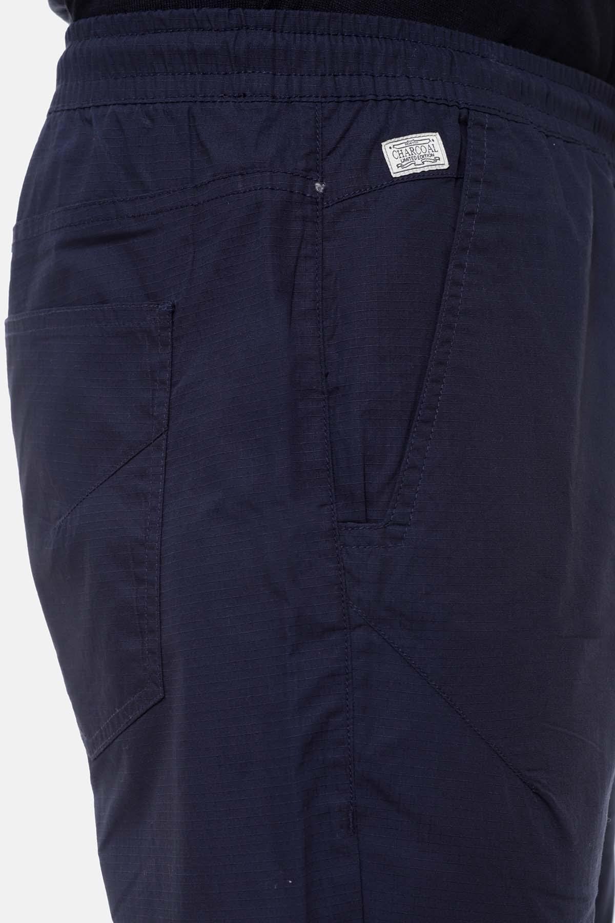 Navy casual trousers close-up of back pocket and logo patch at waistband