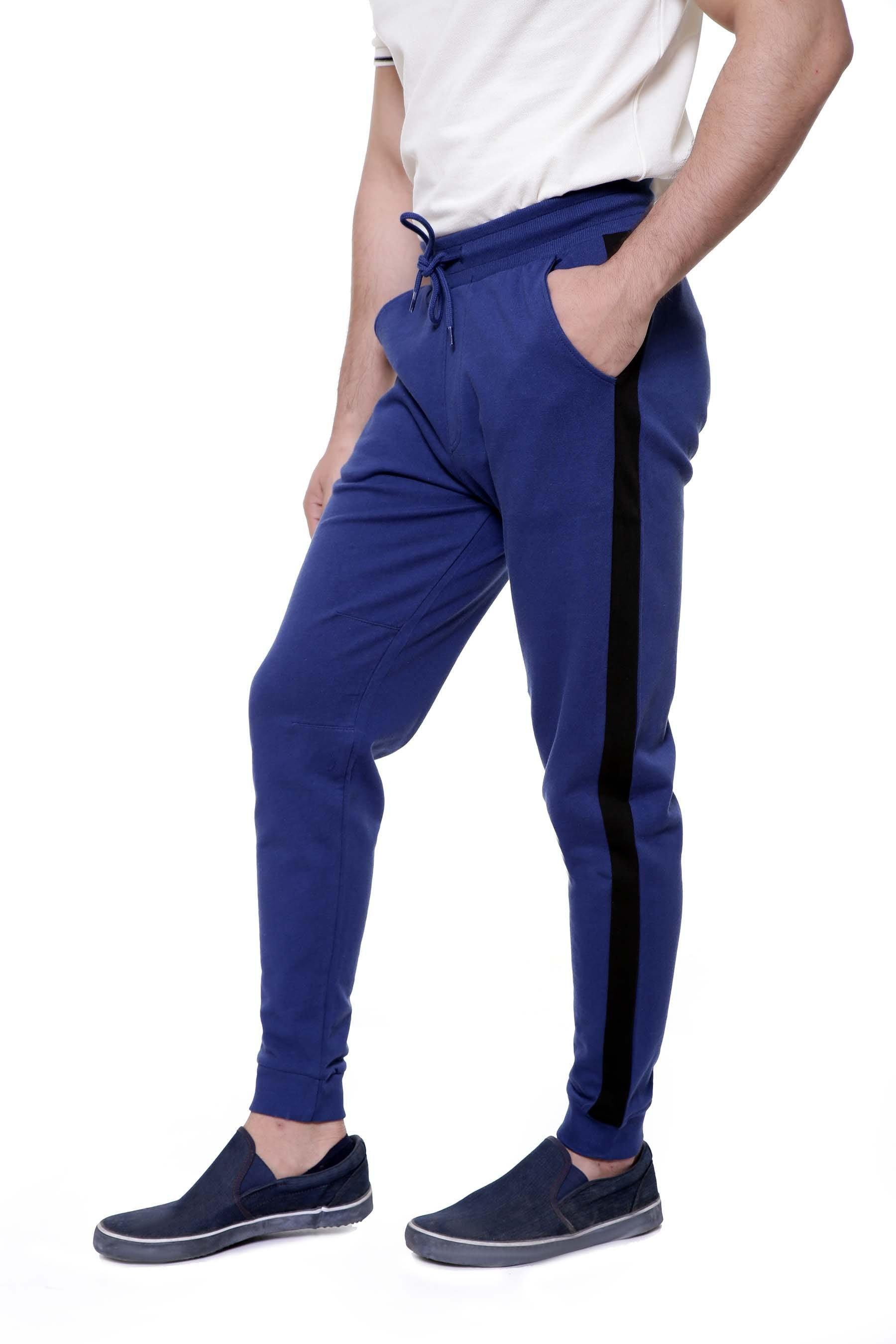 Blue casual trousers with black side stripe, drawstring waist, and ankle cuffs