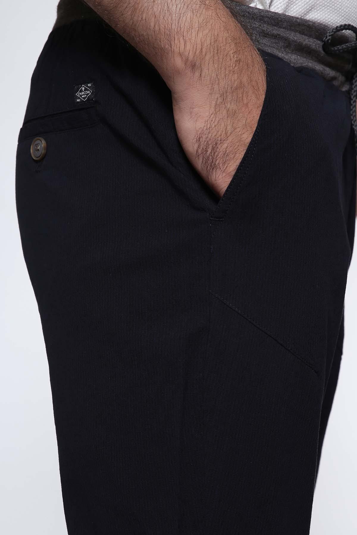 Navy casual trouser pocket detail with button closure and stitched seam