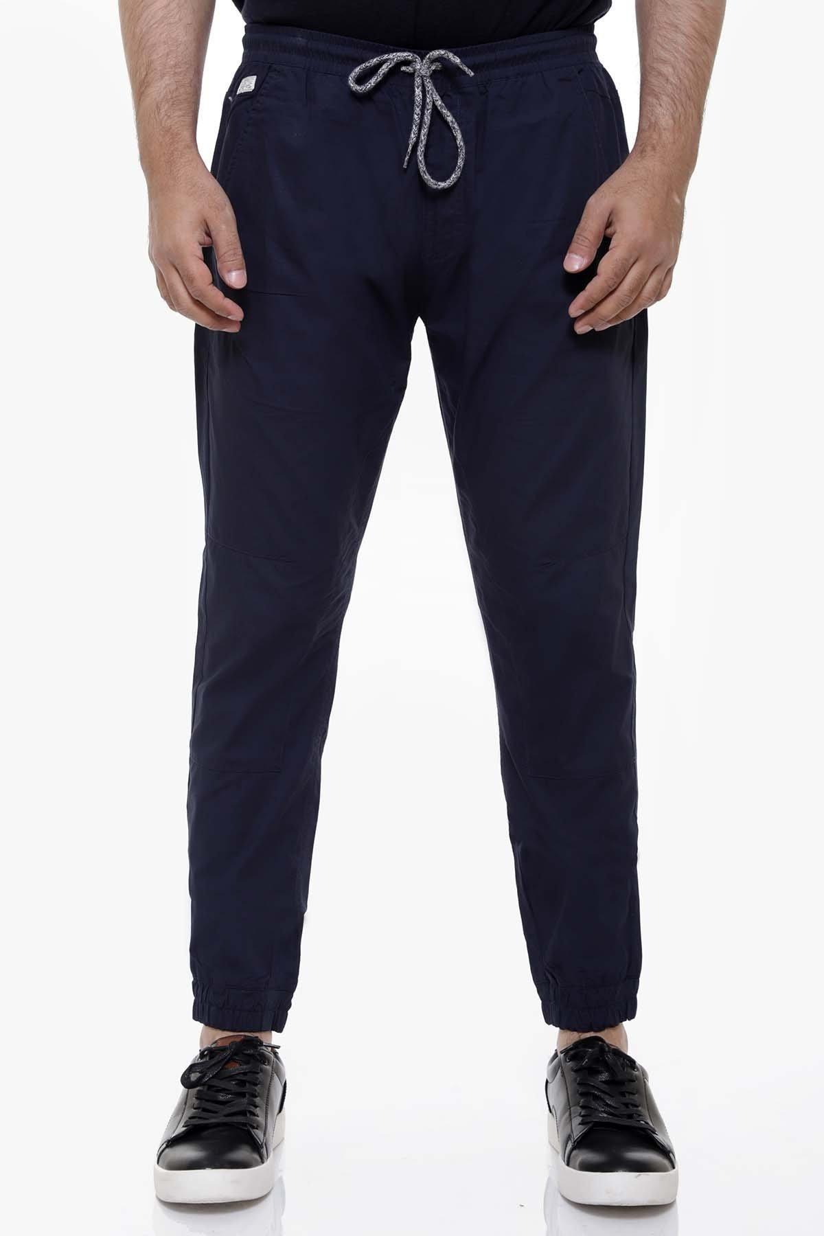 Navy casual trousers with drawstring waist, front pockets, and tapered ankle cuffs