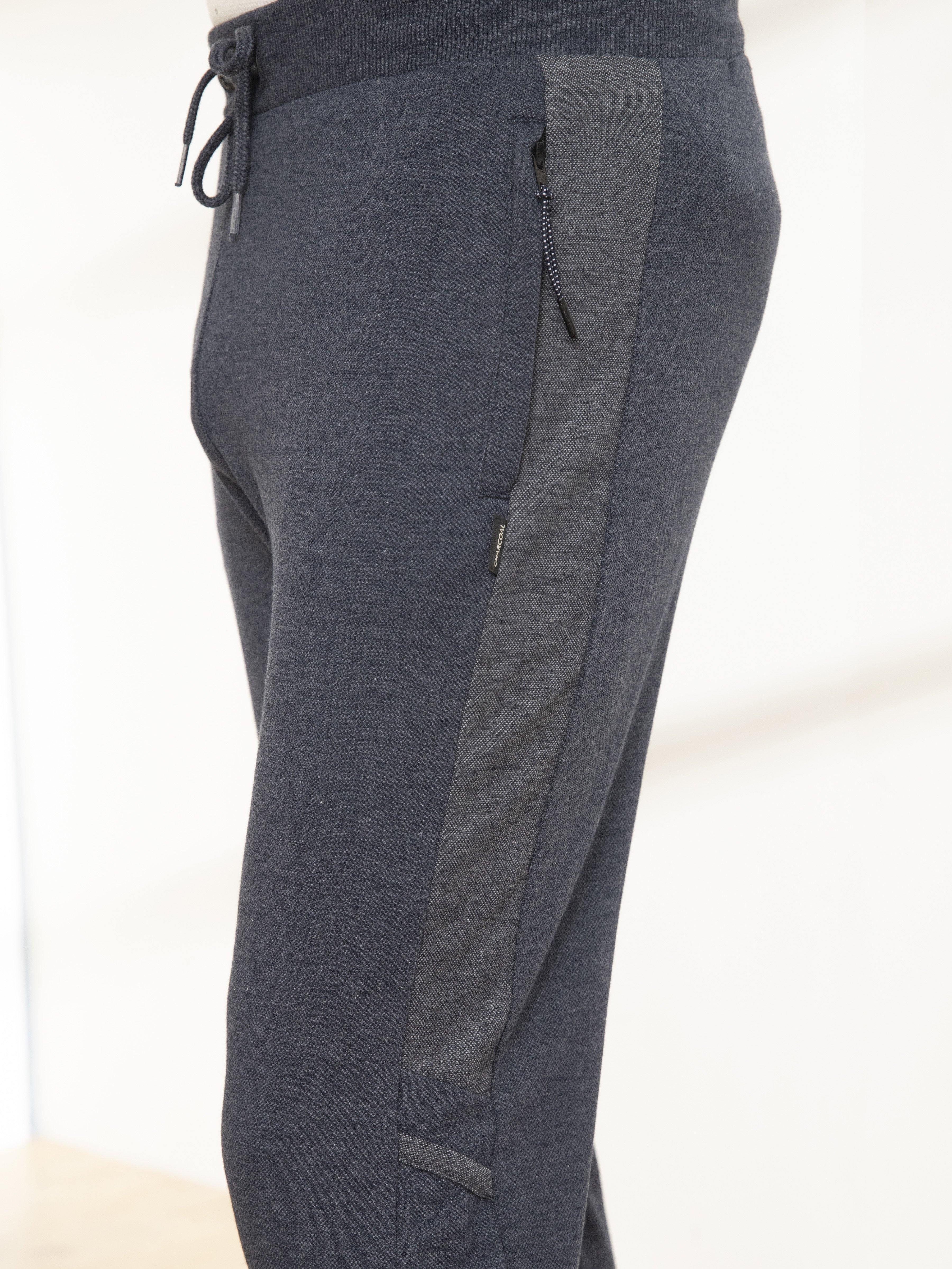 Indigo melange casual trousers close-up: side pocket with contrast inner panel