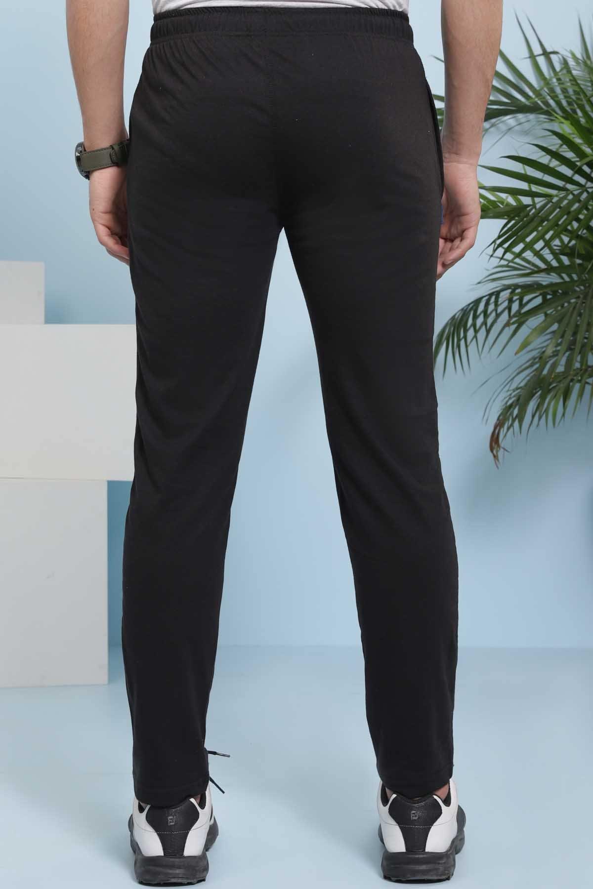 Black sleep trousers shown from back with tapered legs and elastic waistband.