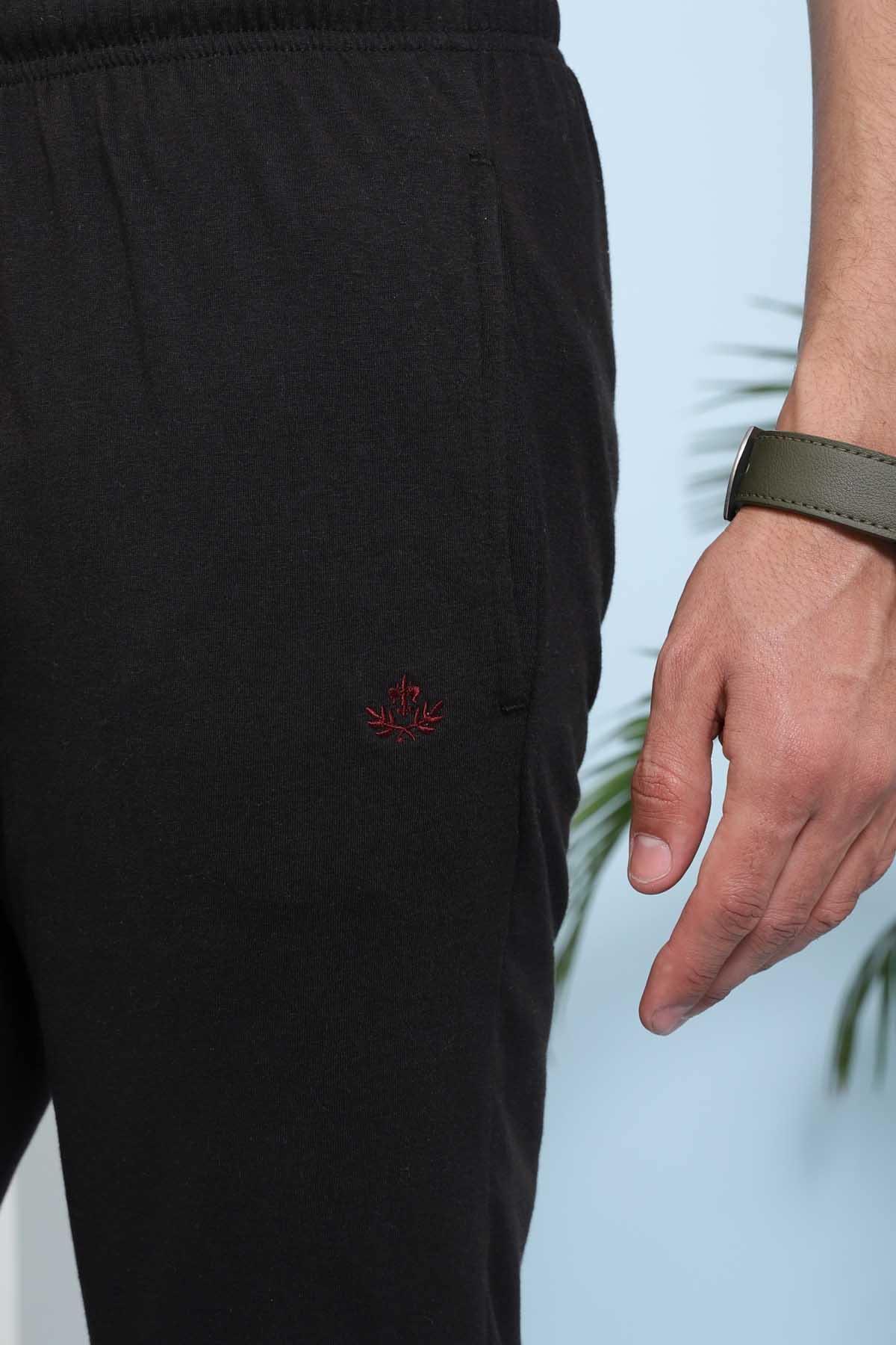 Black sleep trousers with embroidered logo on leg and gathered elastic waistband.