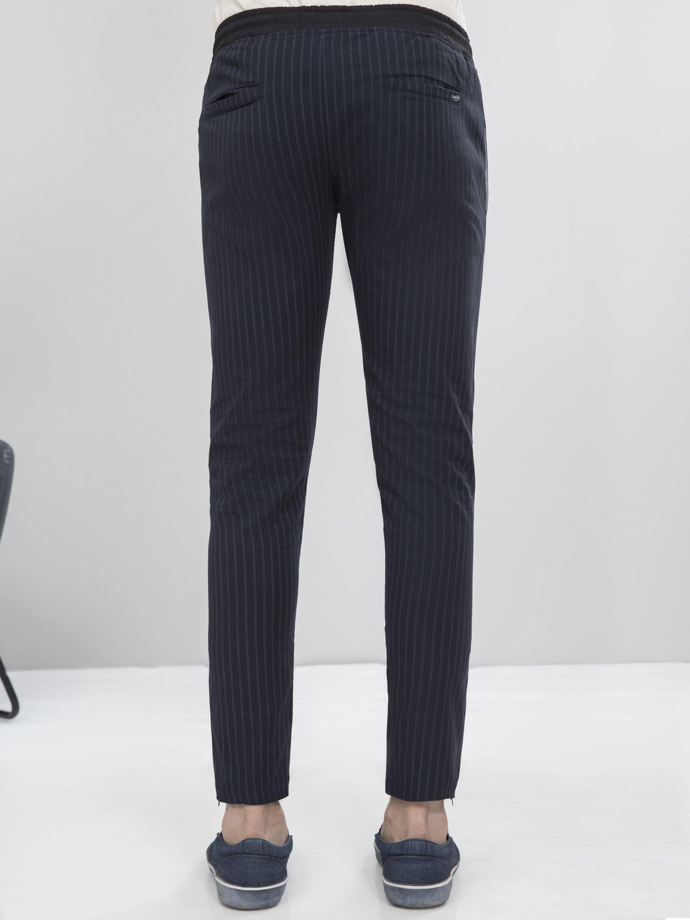 Charcoal grey tapered casual trousers, back view with ankle-length cuff