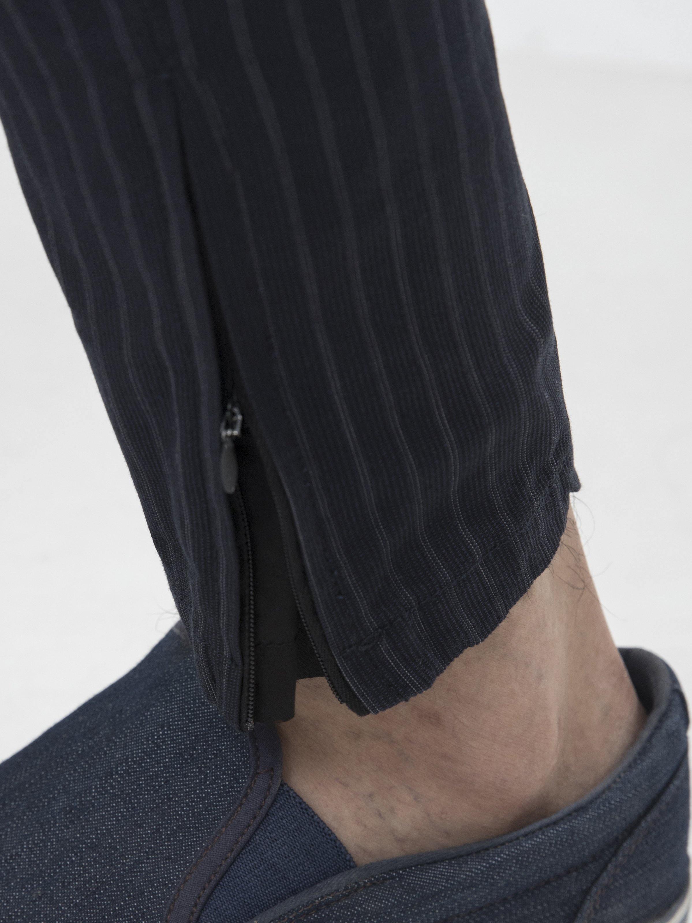 Charcoal grey trouser hem with zipper detail and tapered cuff