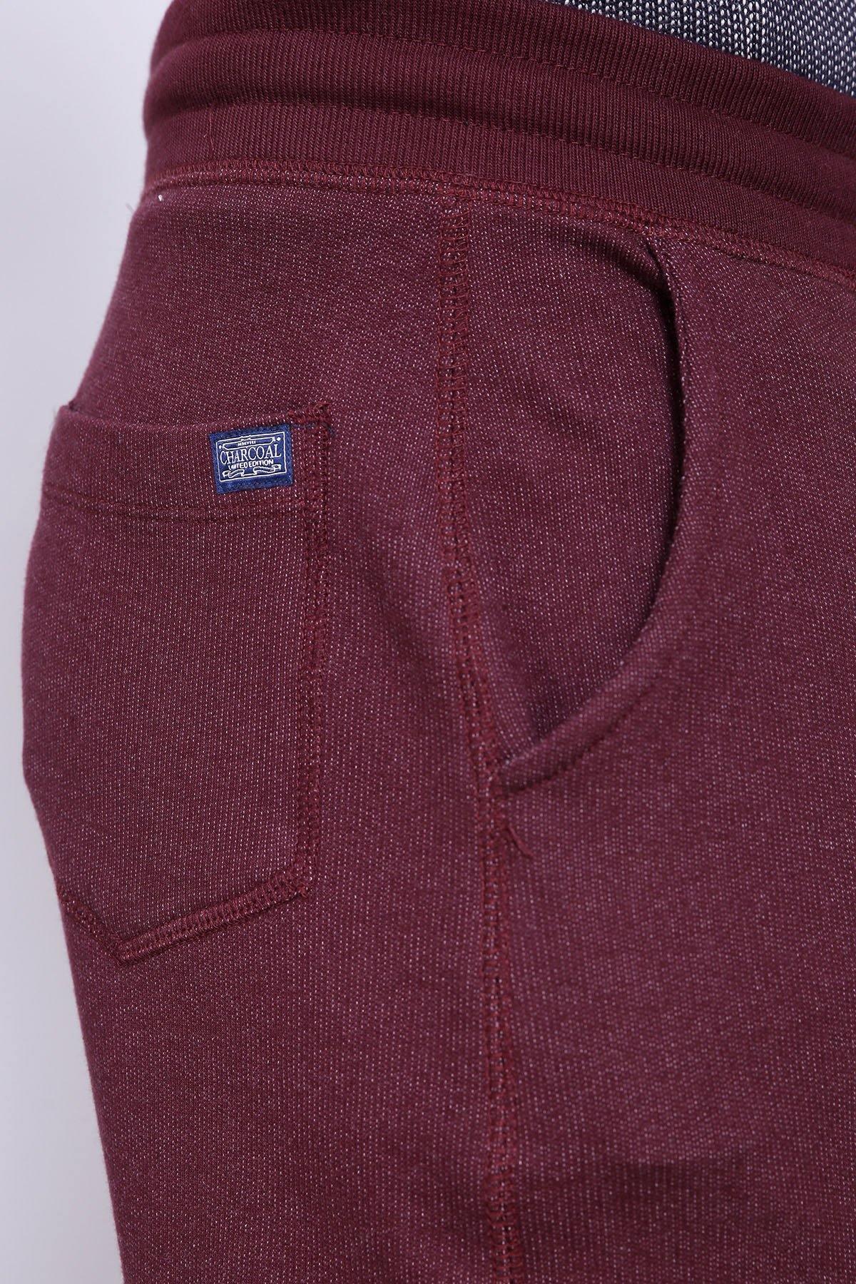 Maroon trouser back pocket with woven logo patch and seam details