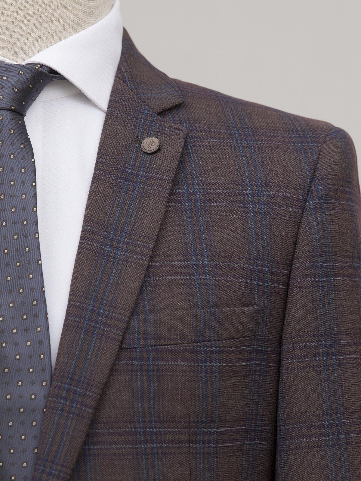 Brown check suit jacket lapel with circular button and welt pocket