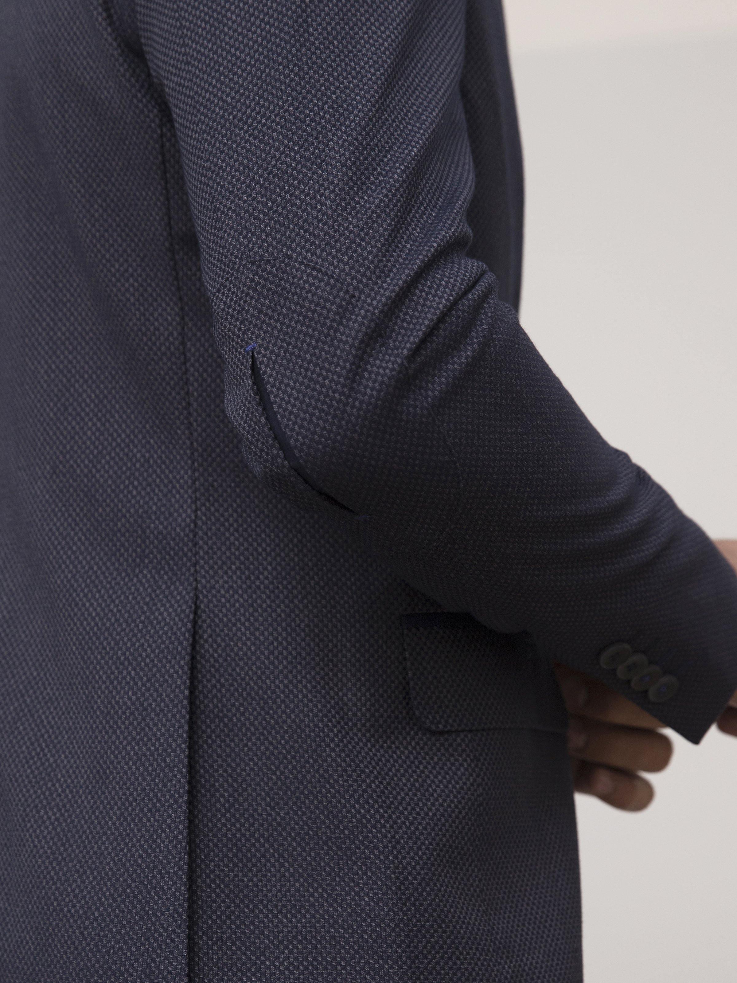 Slim-fit two-button coat in dark navy, close-up of sleeve cuff and flap pocket