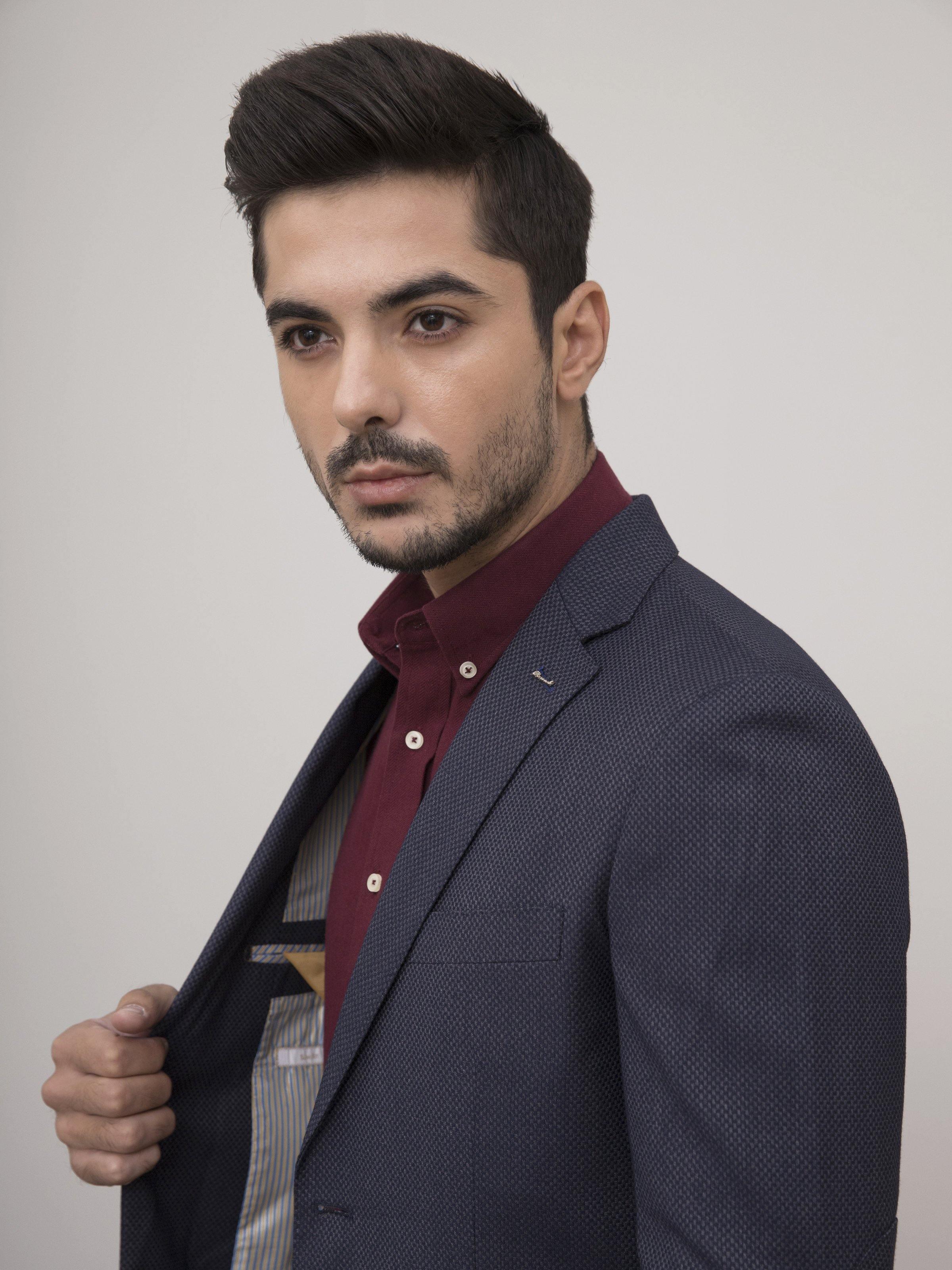 Slim-fit two-button coat in dark navy, side view with notch lapel and textured weave