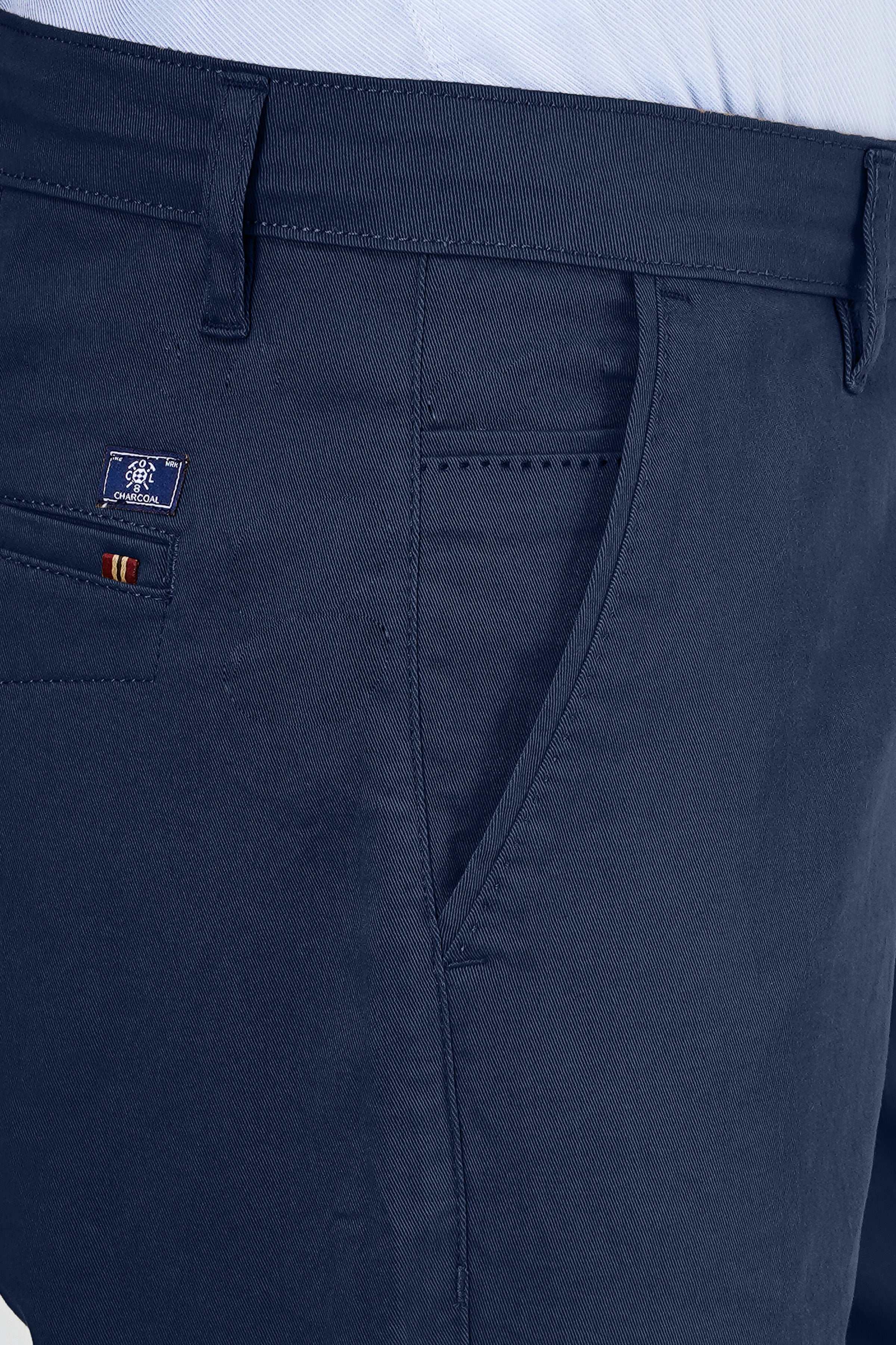 Navy casual pants close-up of side pocket, waistband seam, and logo label