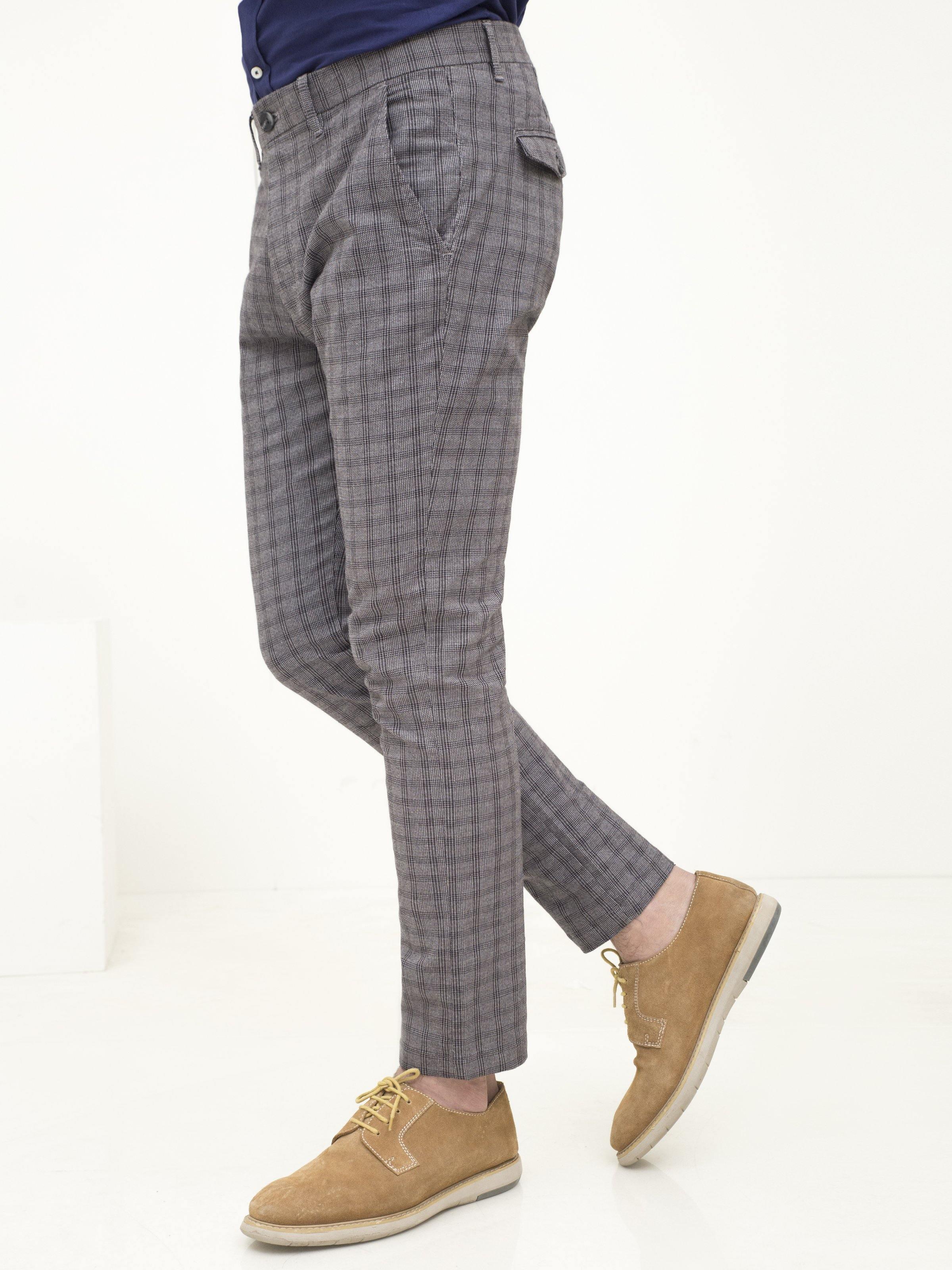 Grey plaid pants with slanted front pockets and belt loops