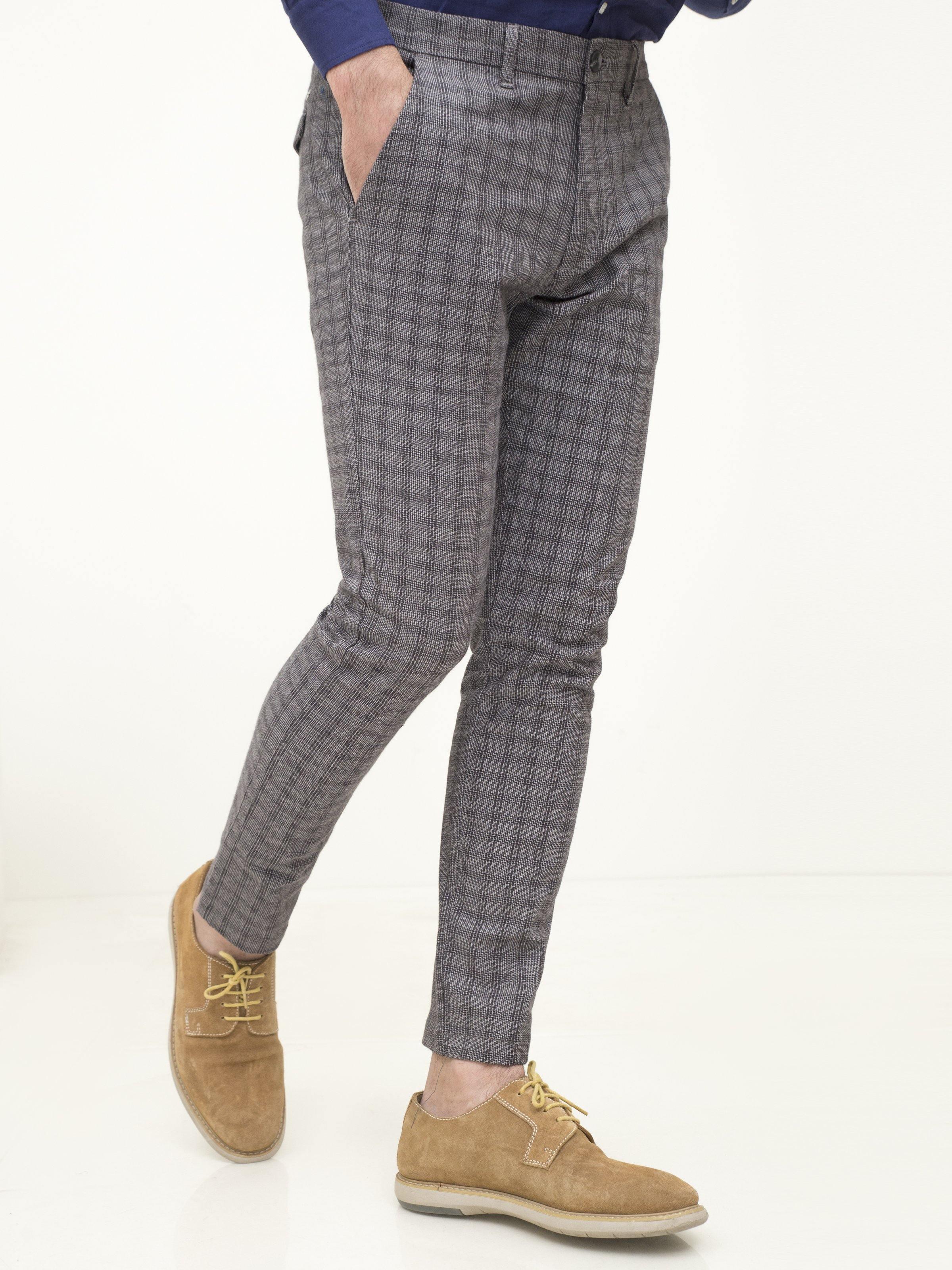 Grey plaid tapered pants with slanted side pockets and ankle-length hem