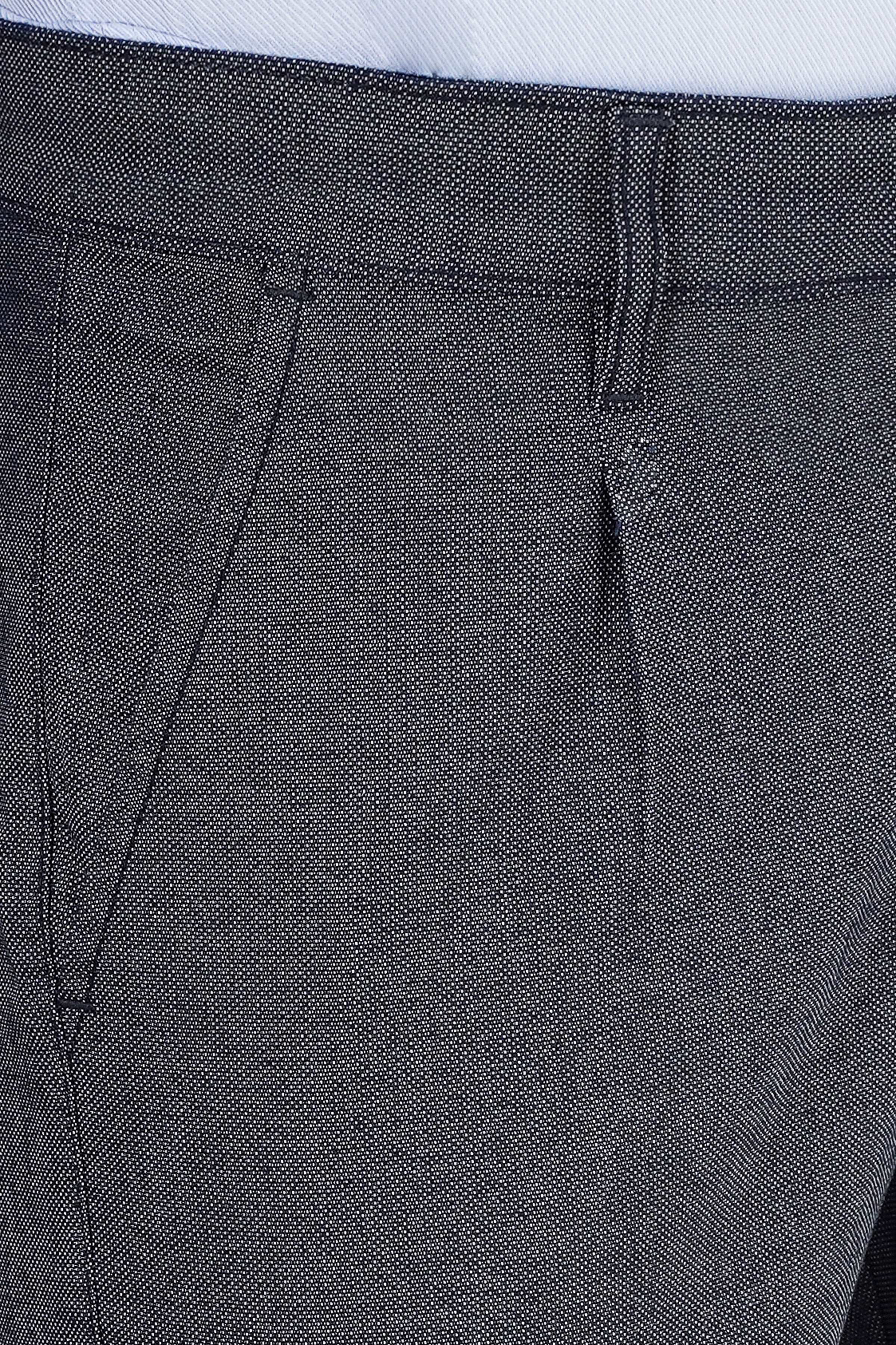 Navy textured pants pocket close-up with stitching and waistband seam