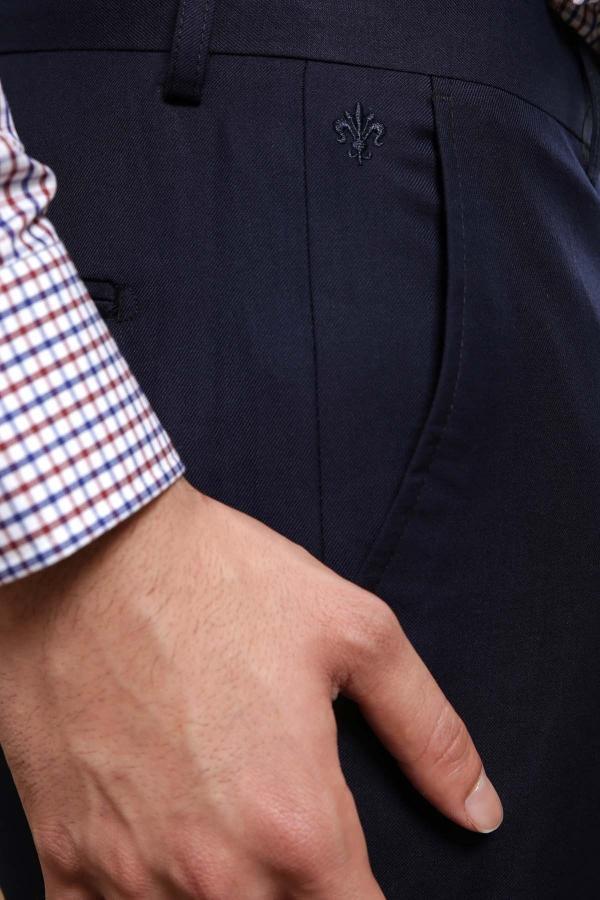 Navy dress pants detail: embroidered fleur-de-lis and front pocket