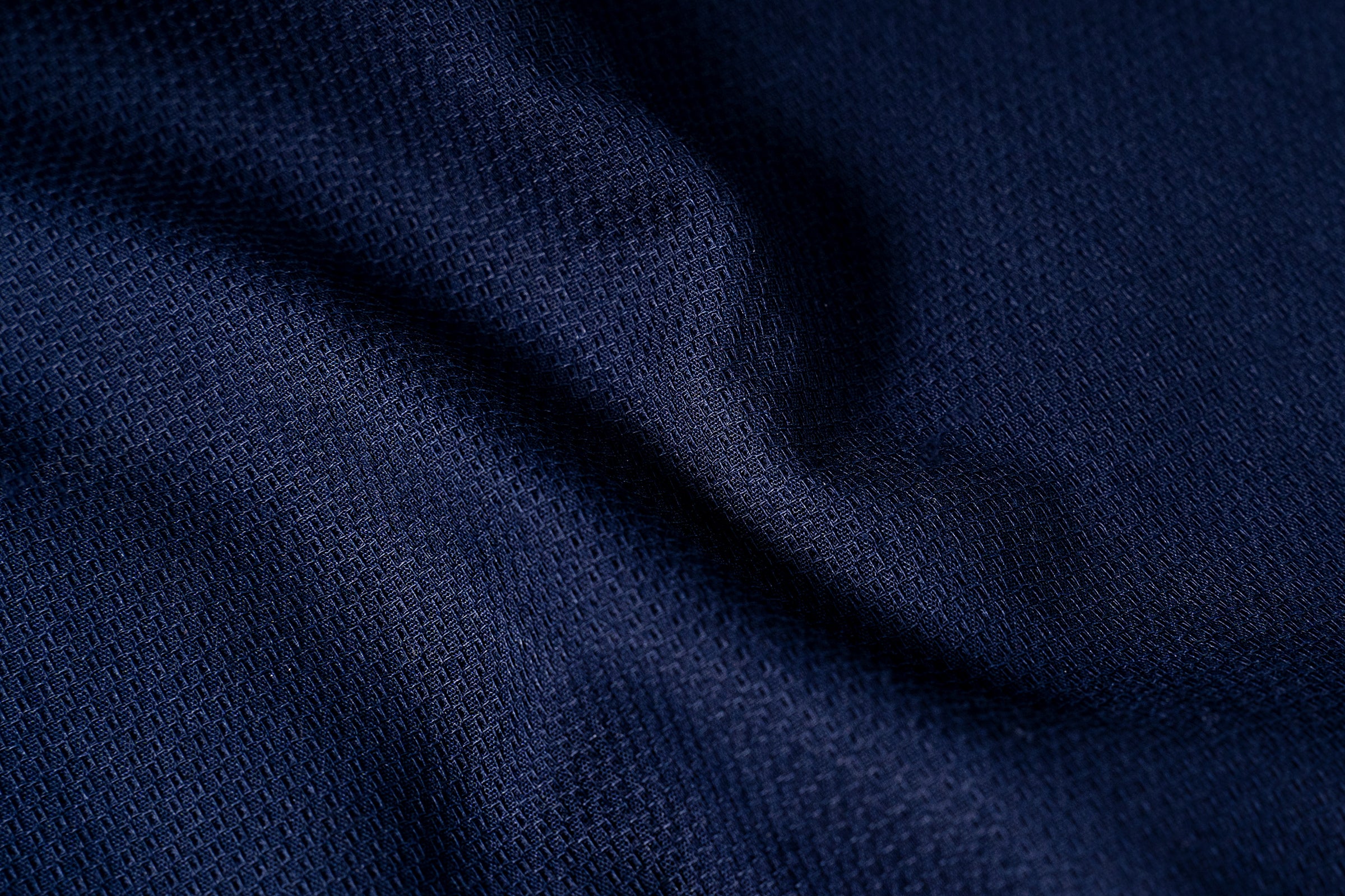 Navy self-textured fabric close-up with fine woven texture