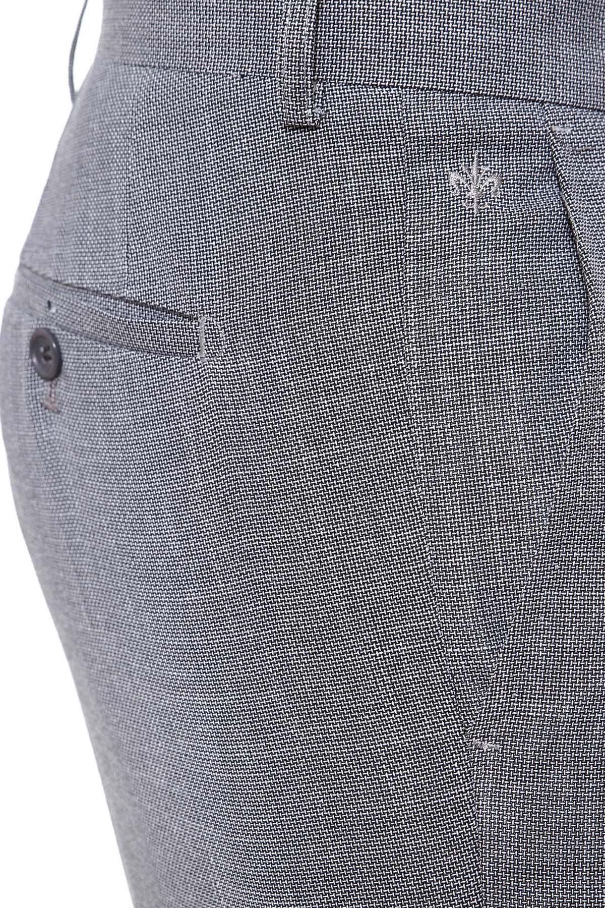 Slim-fit dress pants fabric close-up with side pocket and stitched button