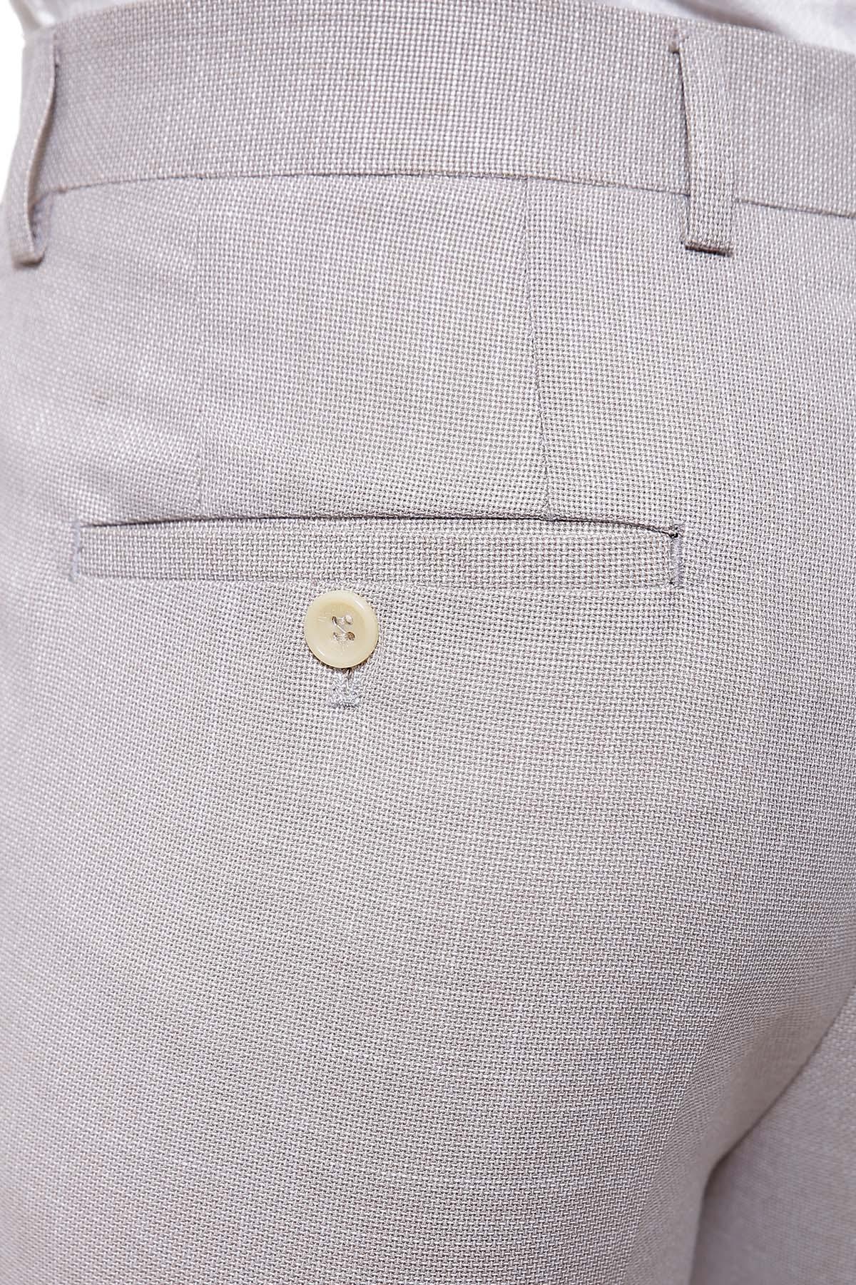 Light khaki slim-fit dress pants close-up of coin pocket and button