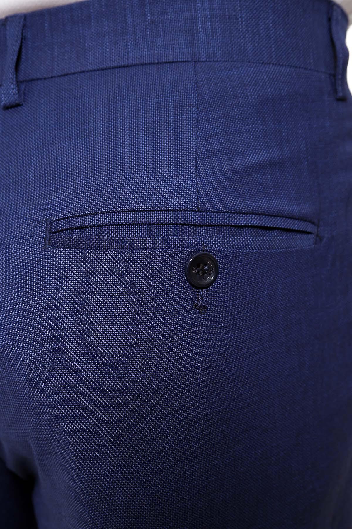 Blue smart-fit dress pants close-up of waistband and button front