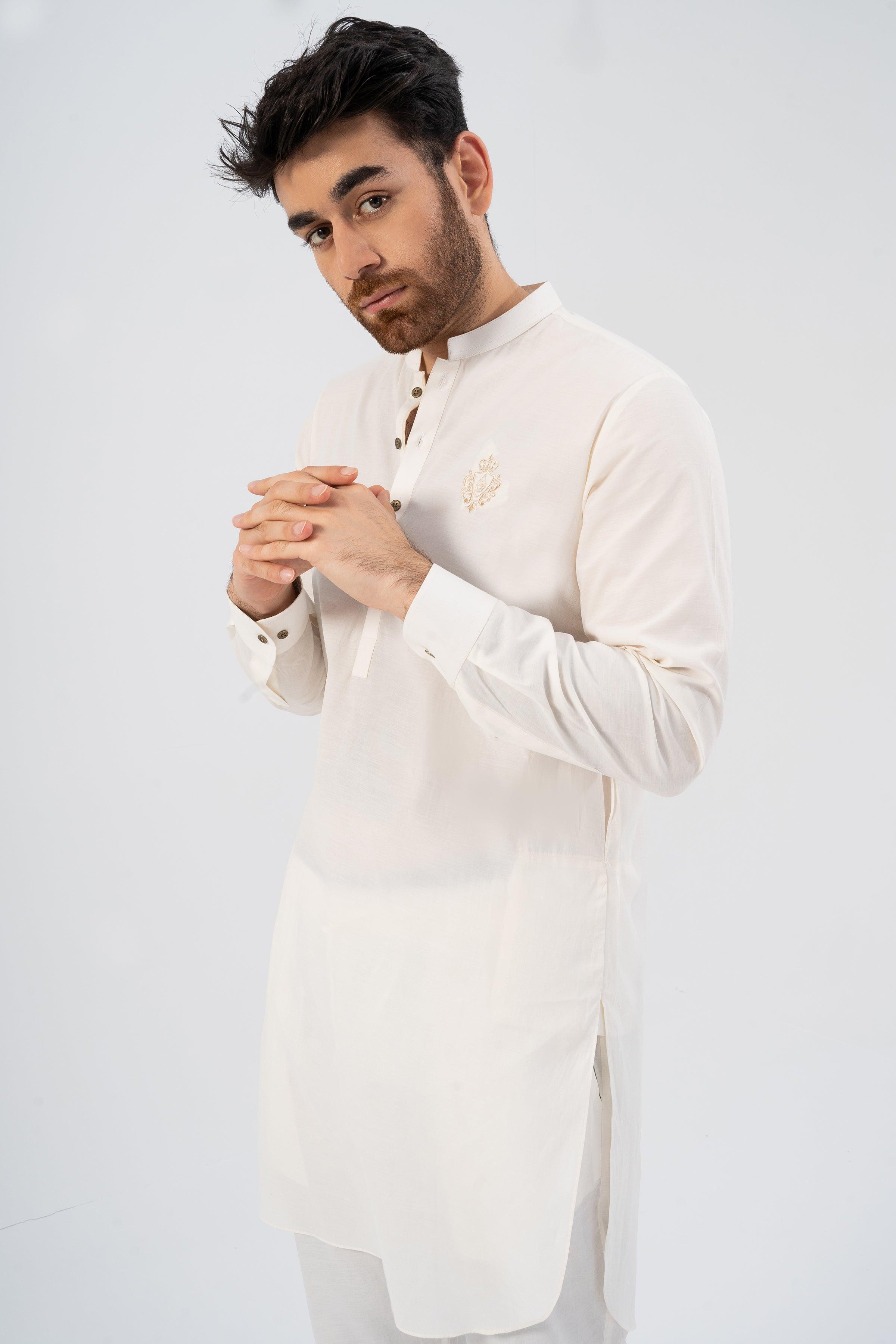 Embroidered white kurta with small chest motif and long sleeves, standing pose