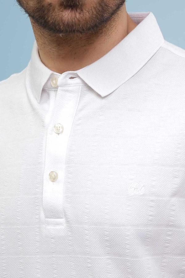 White polo collar with button placket and small chest emblem detail