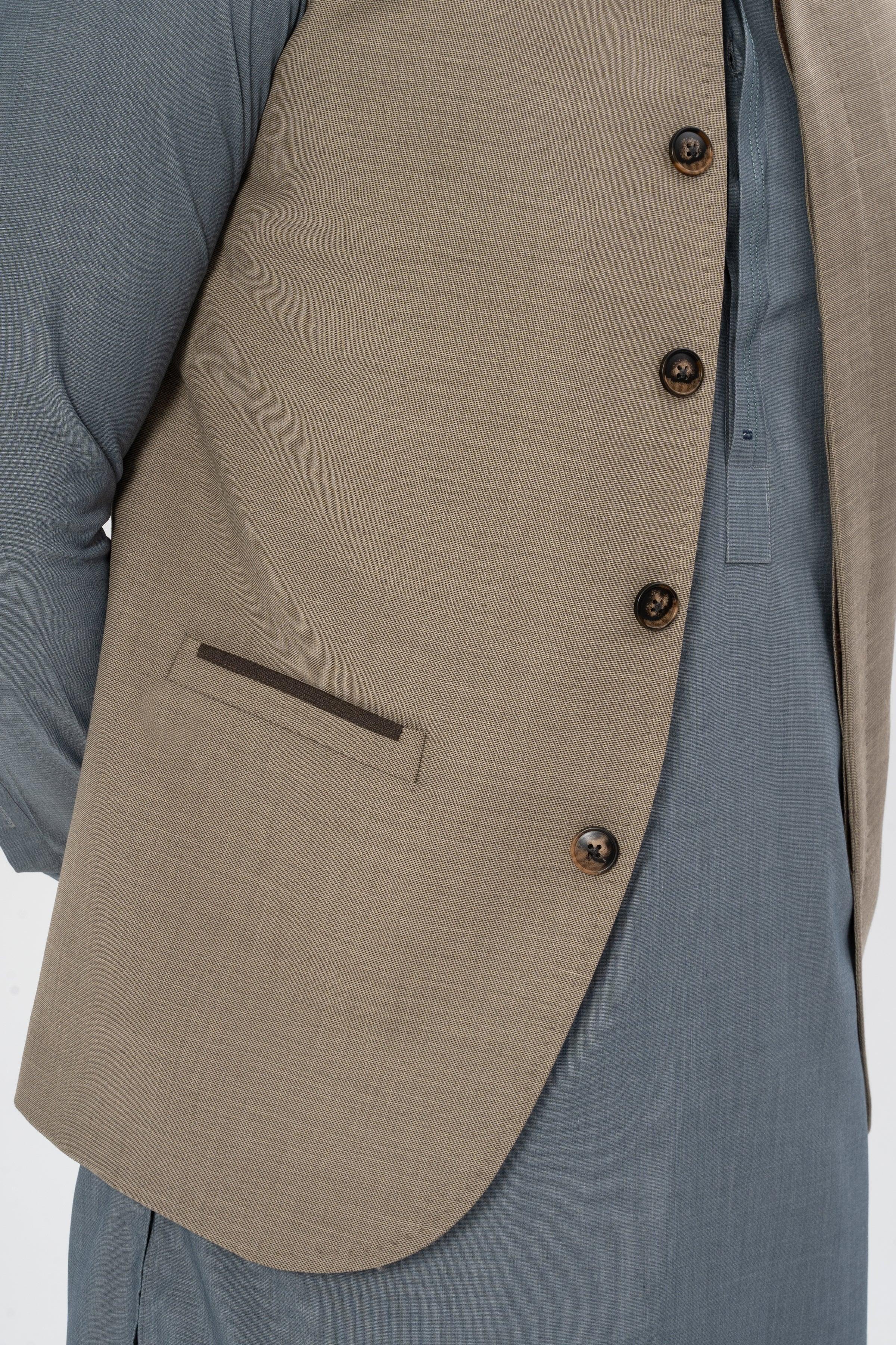 Textured mid-brown waistcoat front close-up with welt pocket and dark buttons