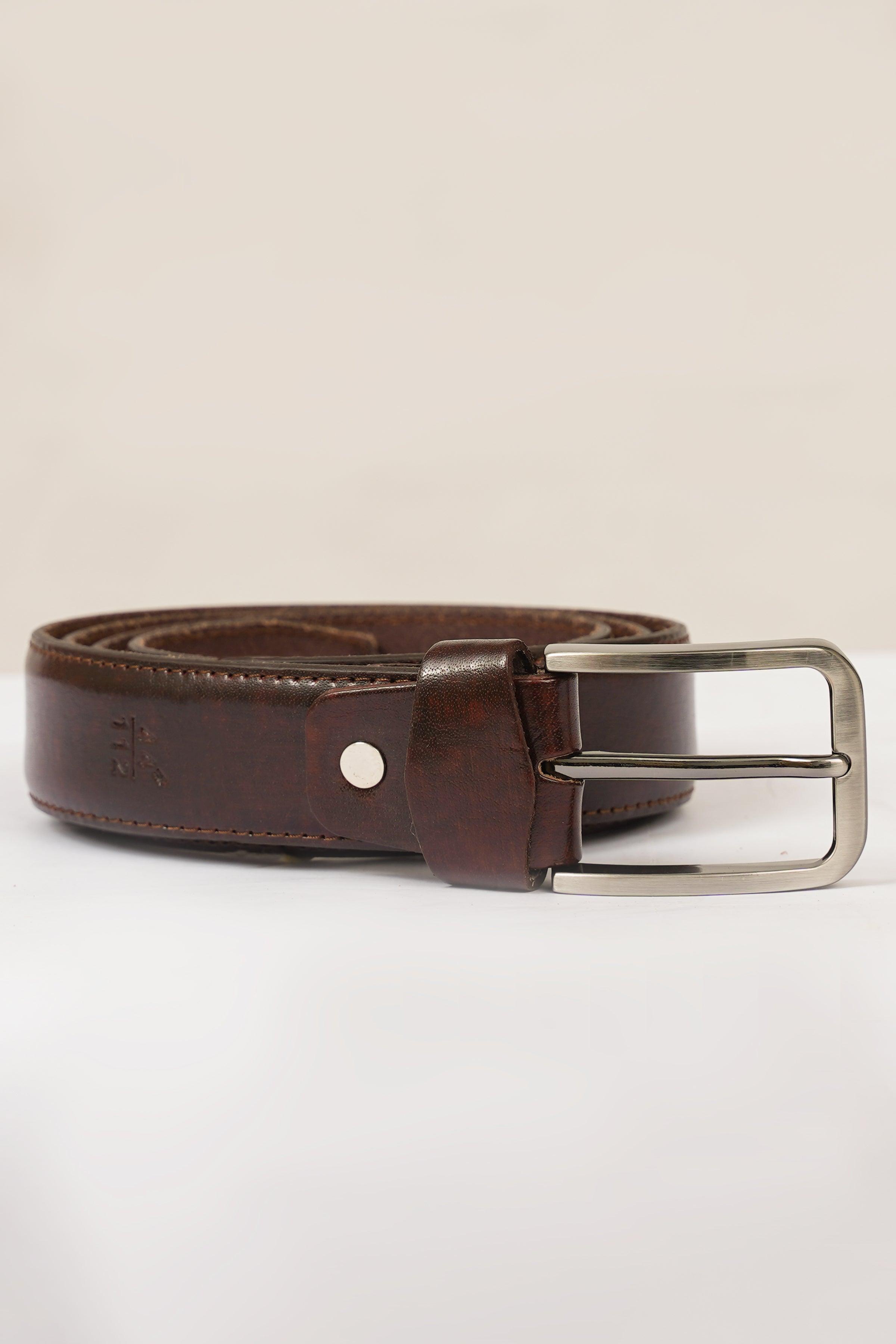 Brown leather belt with silver buckle, stud holes, and stitched keeper loop