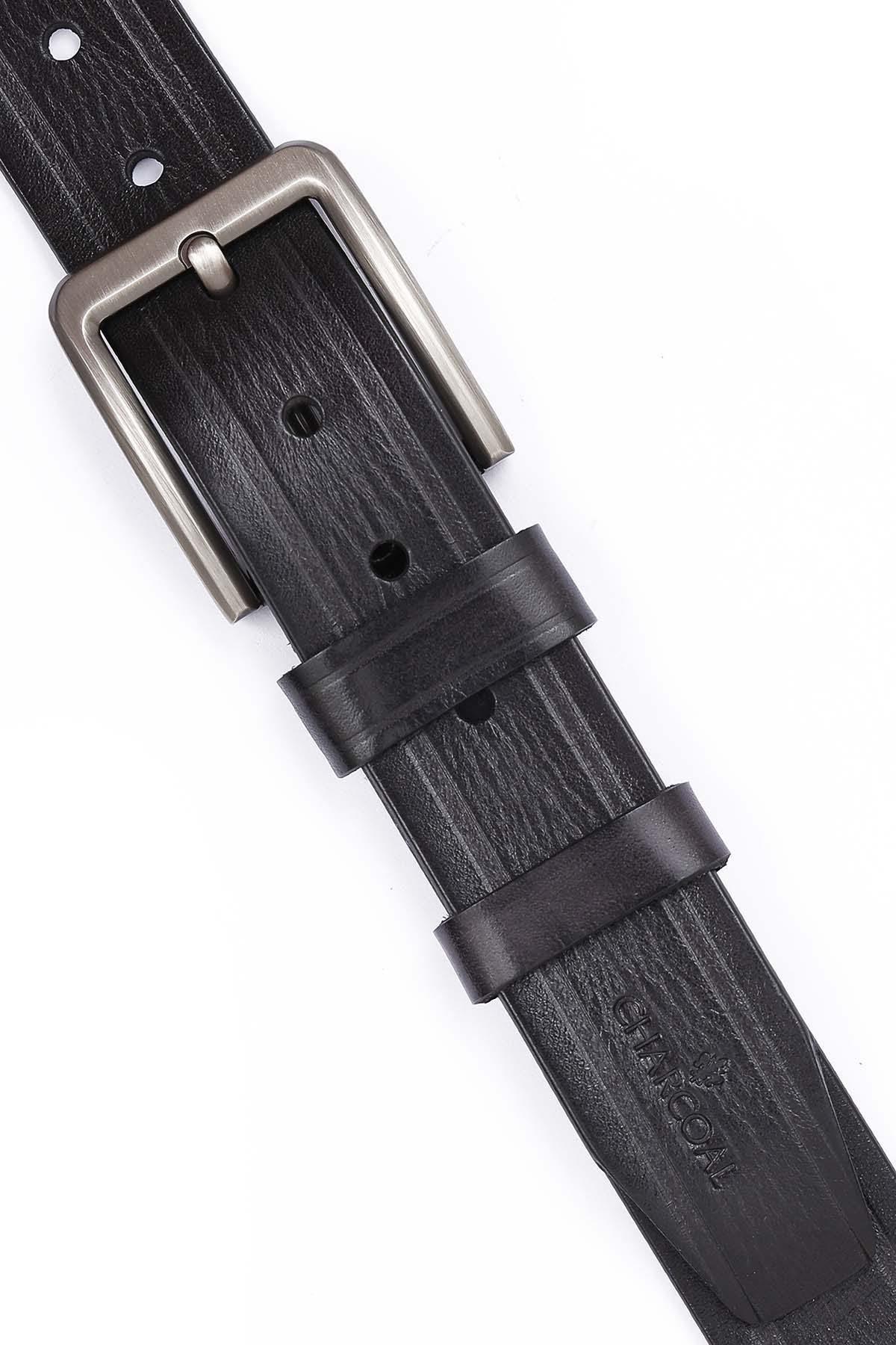 Dark leather belt close-up with keeper strap and brushed metal buckle.