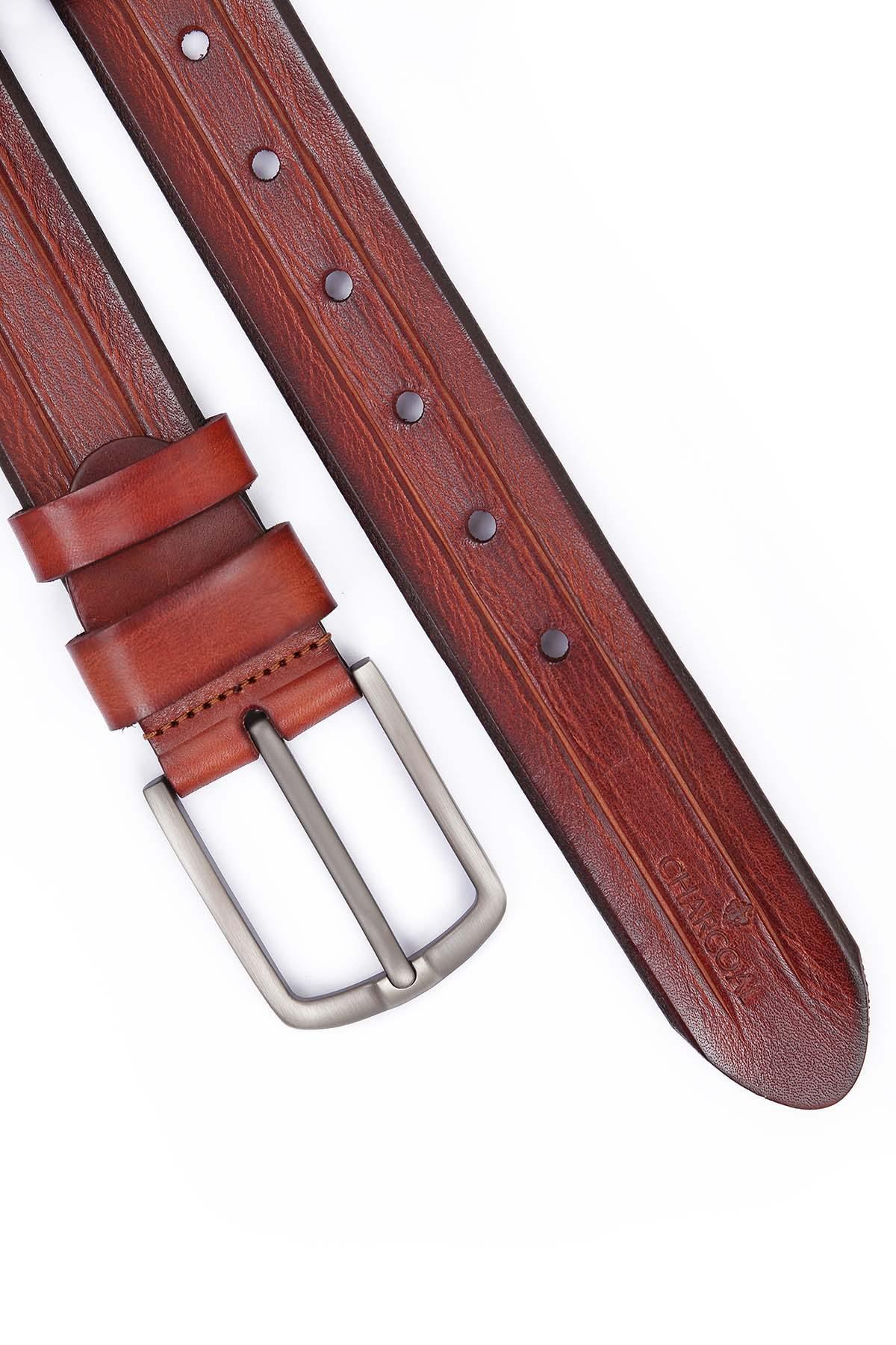 Formal belt with brown leather strap, silver buckle end and row of punched holes