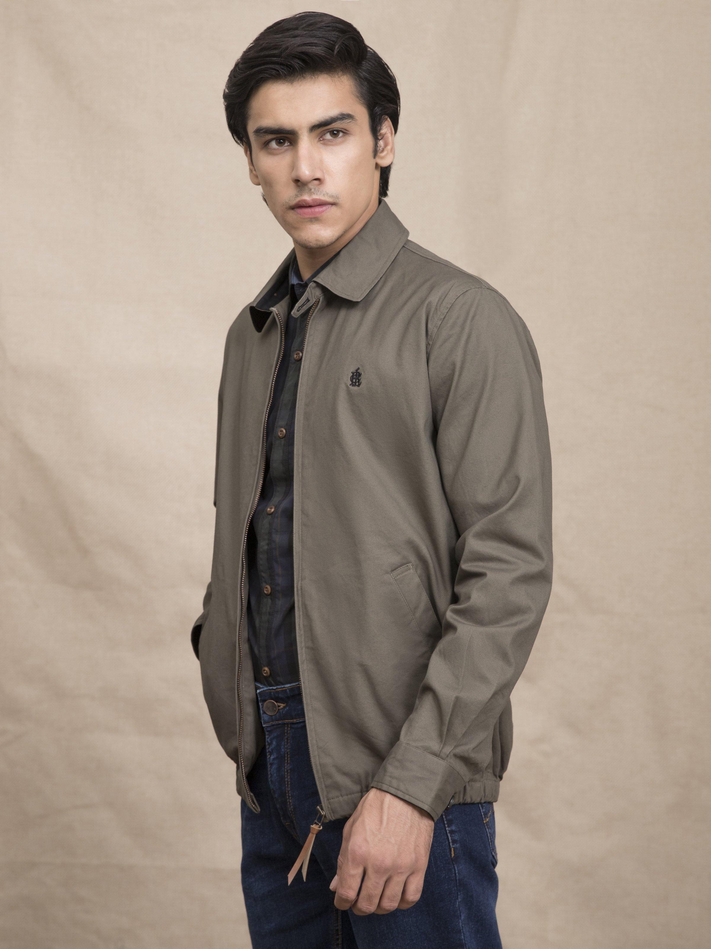 Men's olive collared zip jacket, side view worn over a dark shirt