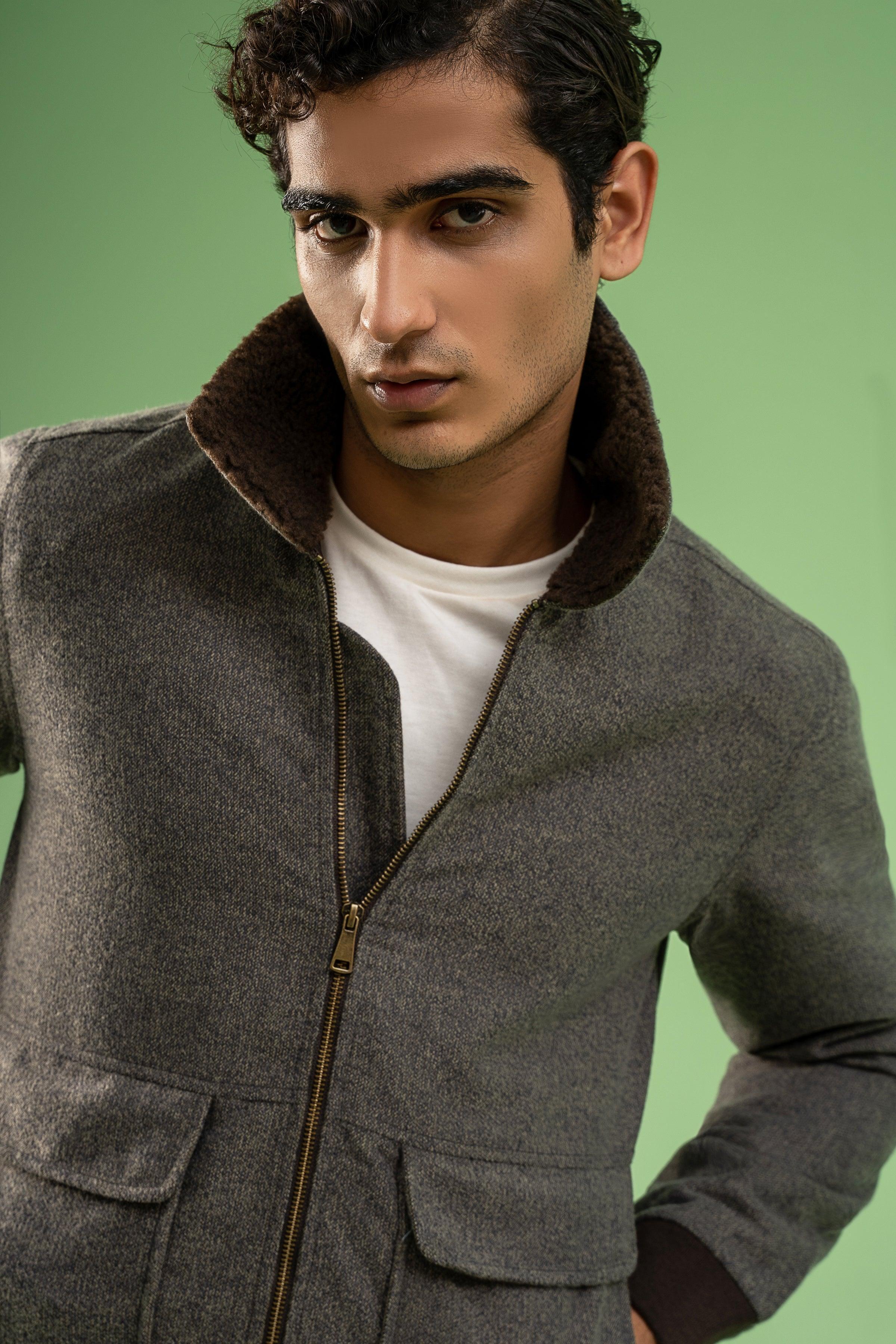 Grey melange wool jacket close-up with dark fur collar and gold-toned zip