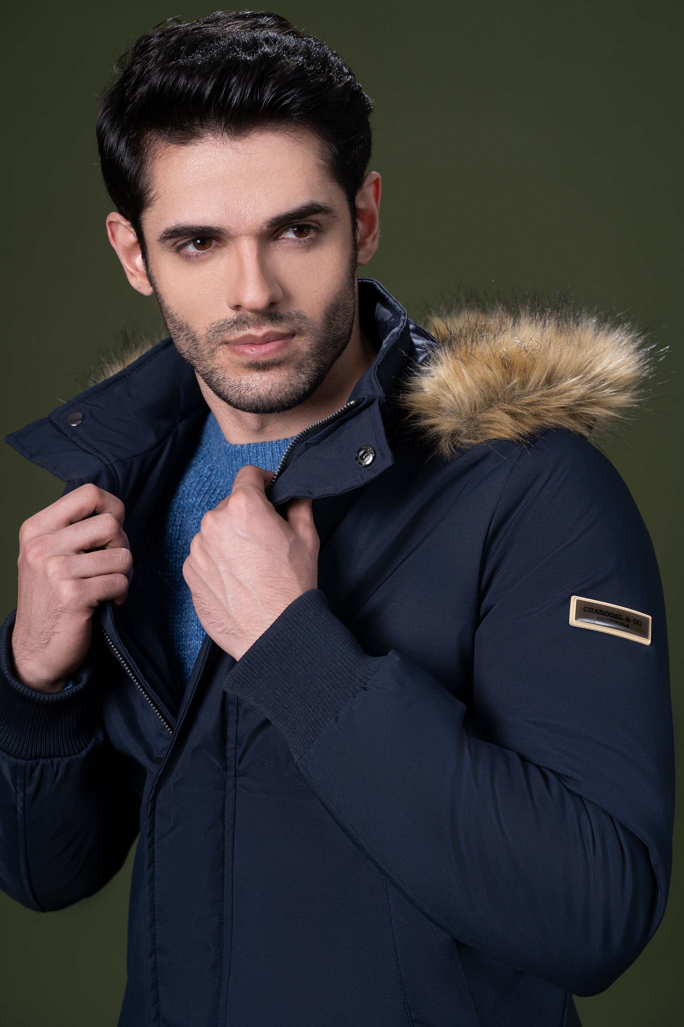 Navy fur-trim hooded jacket close-up with snap buttons at neck