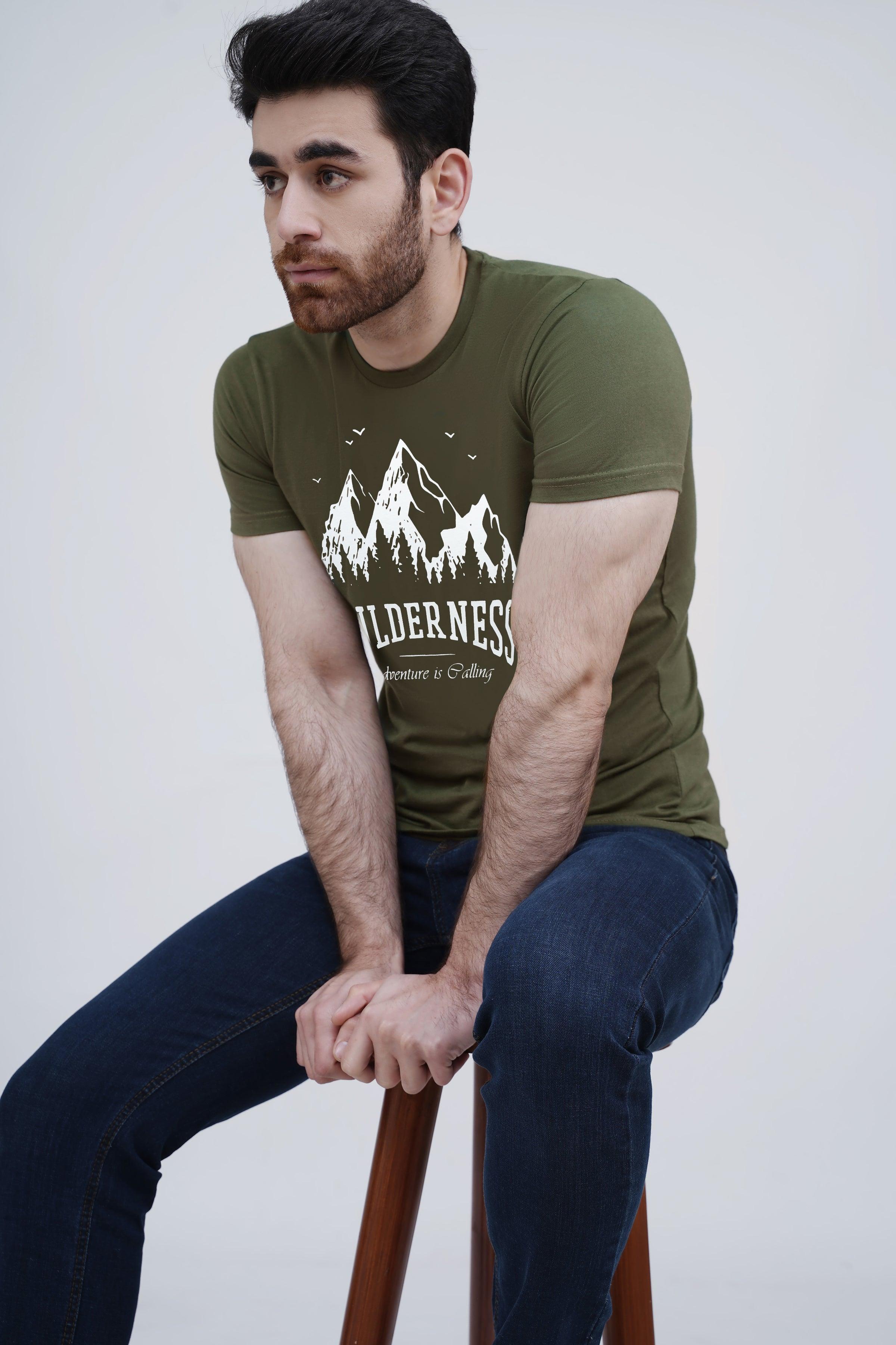 Olive green graphic T-shirt with mountain print, crew neck, seated view