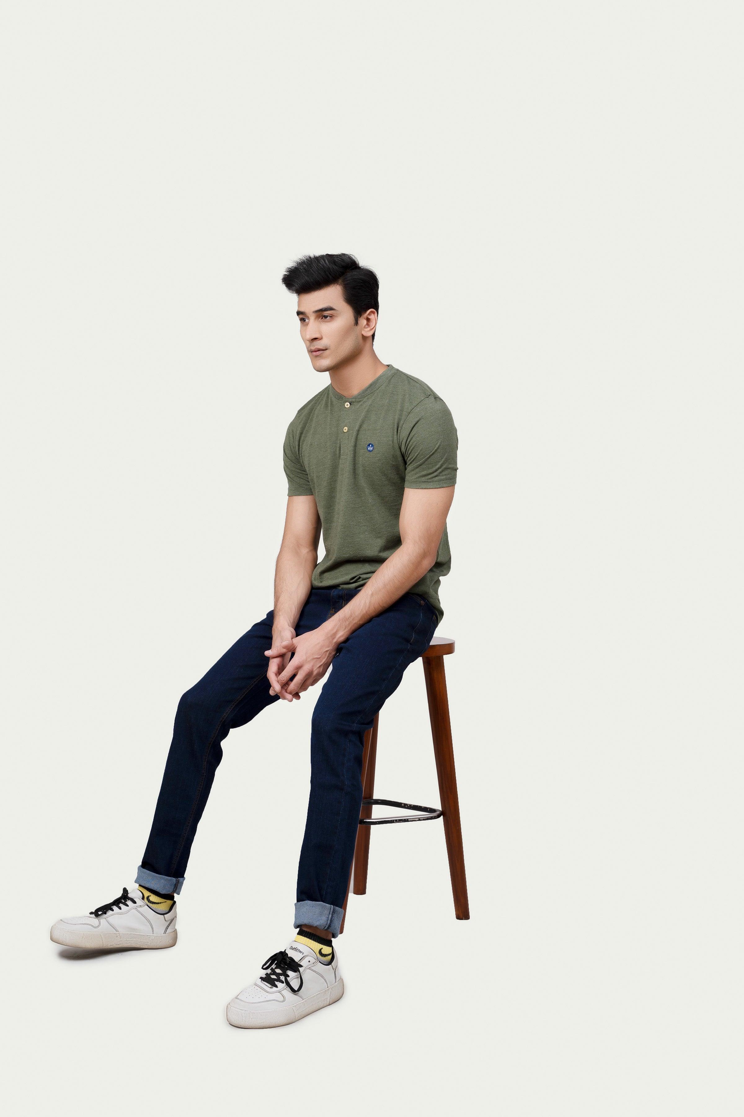 Green henley T-shirt in side profile with two-button placket and small chest logo