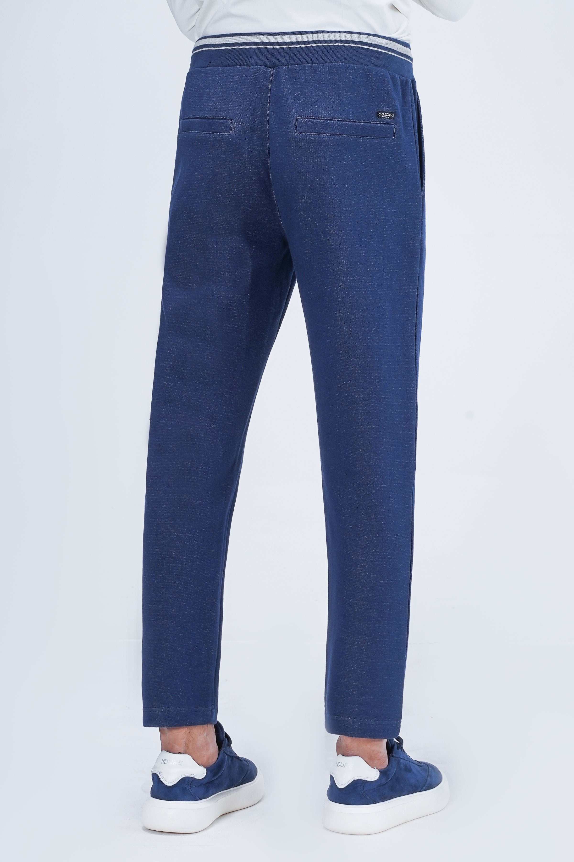 Indigo slim jogger trousers, back view, ribbed waistband and tapered legs