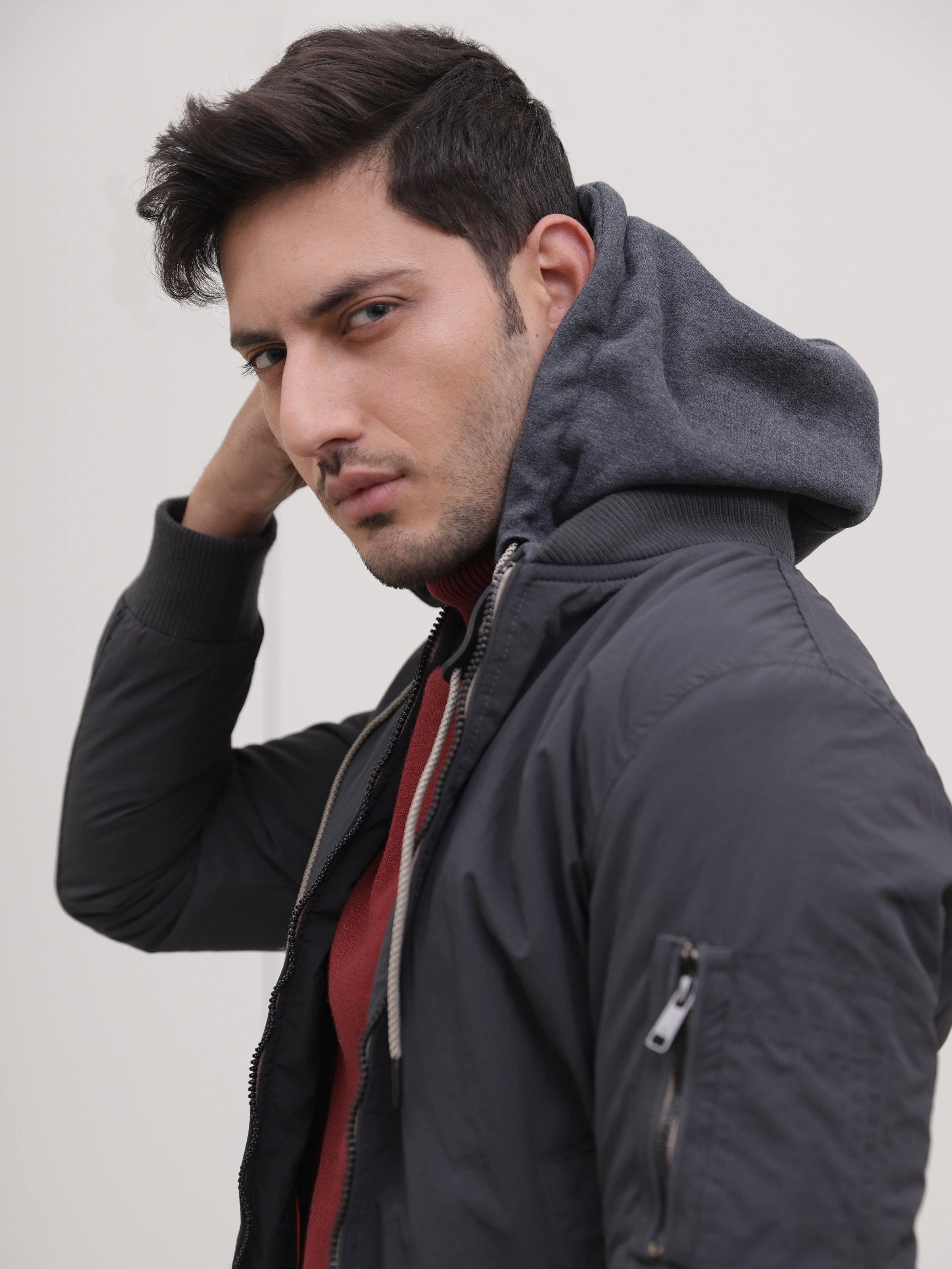 Dark grey jacket hood with ribbed collar edge, visible front seam