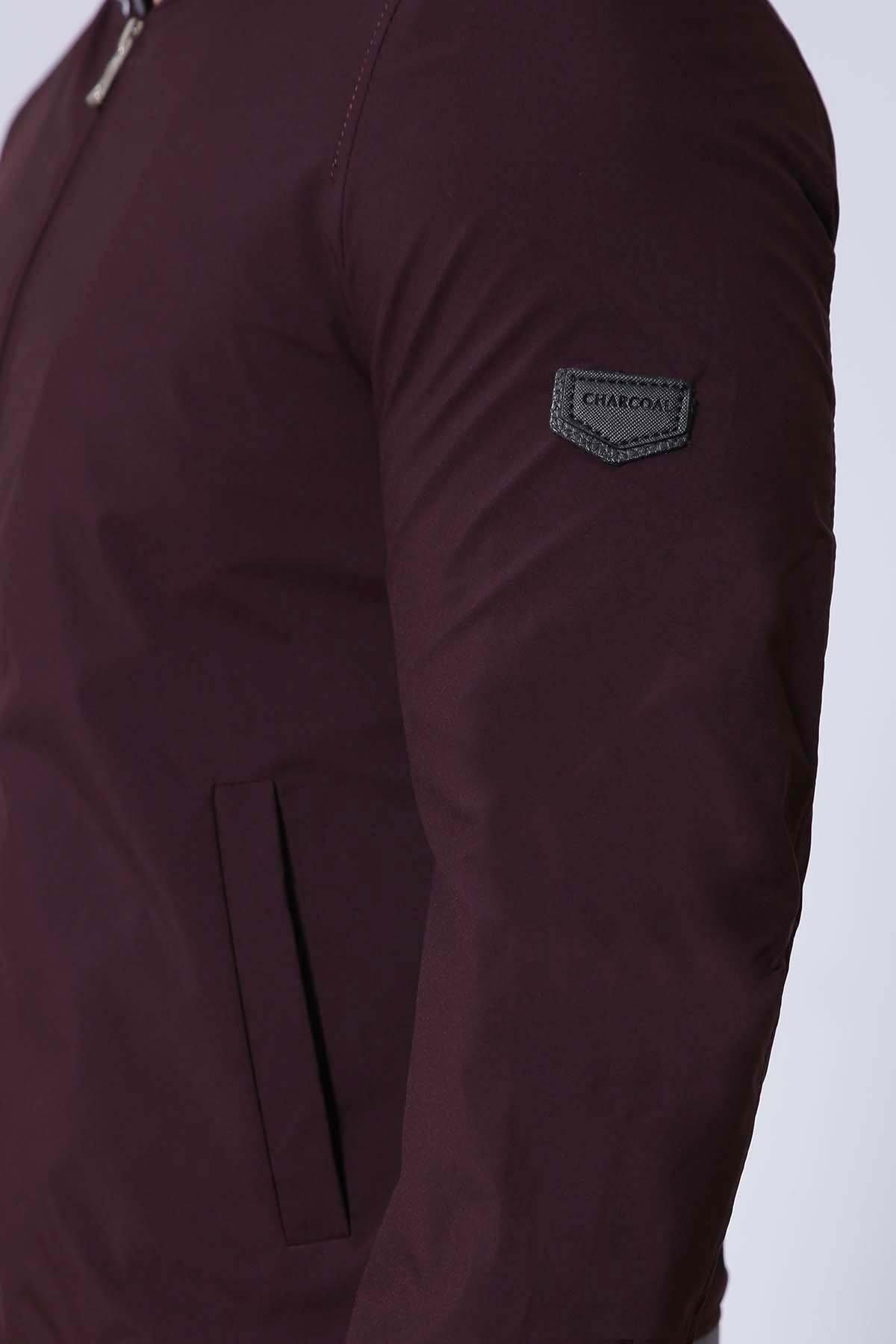 Maroon jacket sleeve with stitched patch logo and side pocket