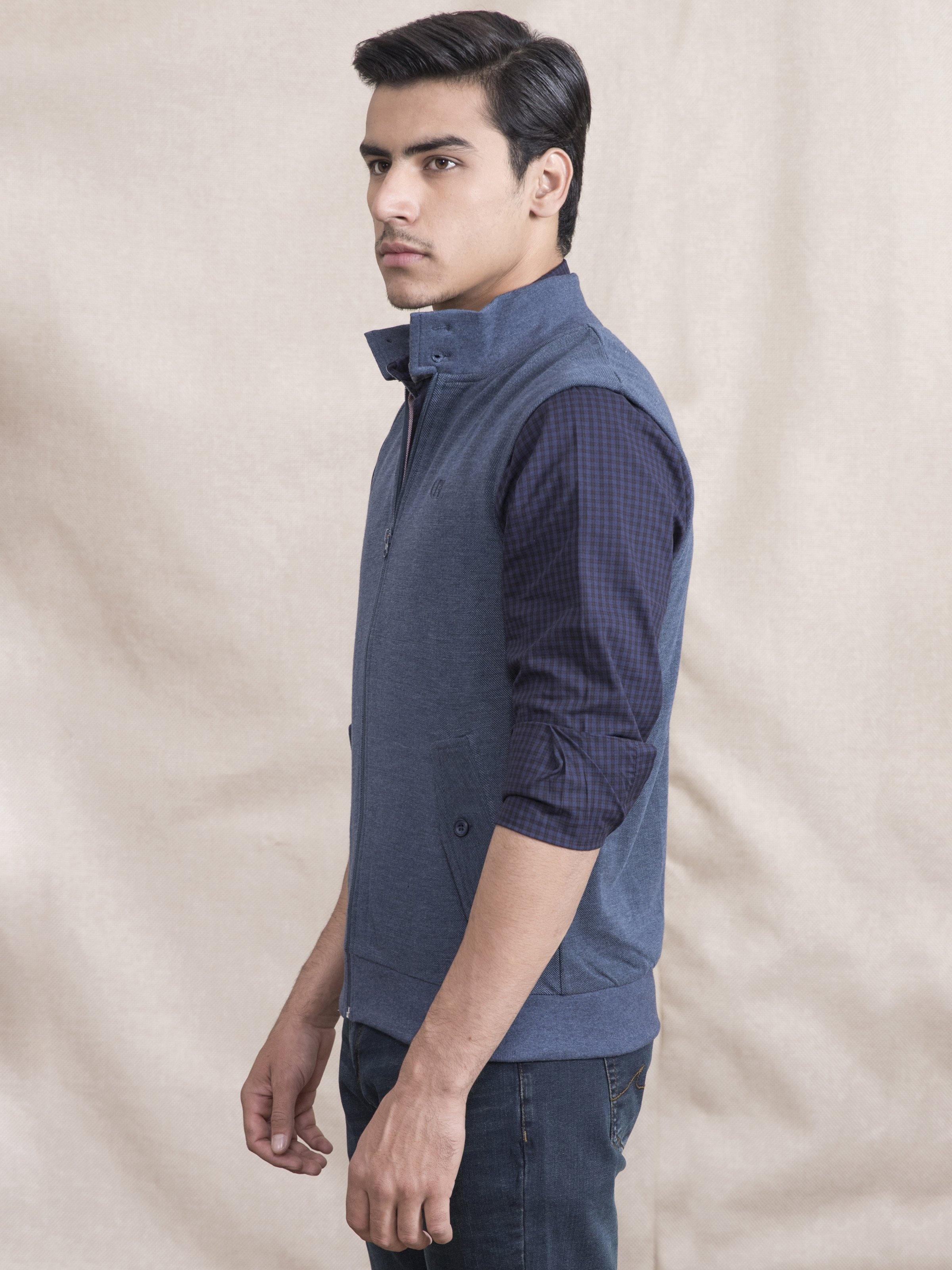 Blue sleeveless zip jacket, side view, with stand collar and front pockets