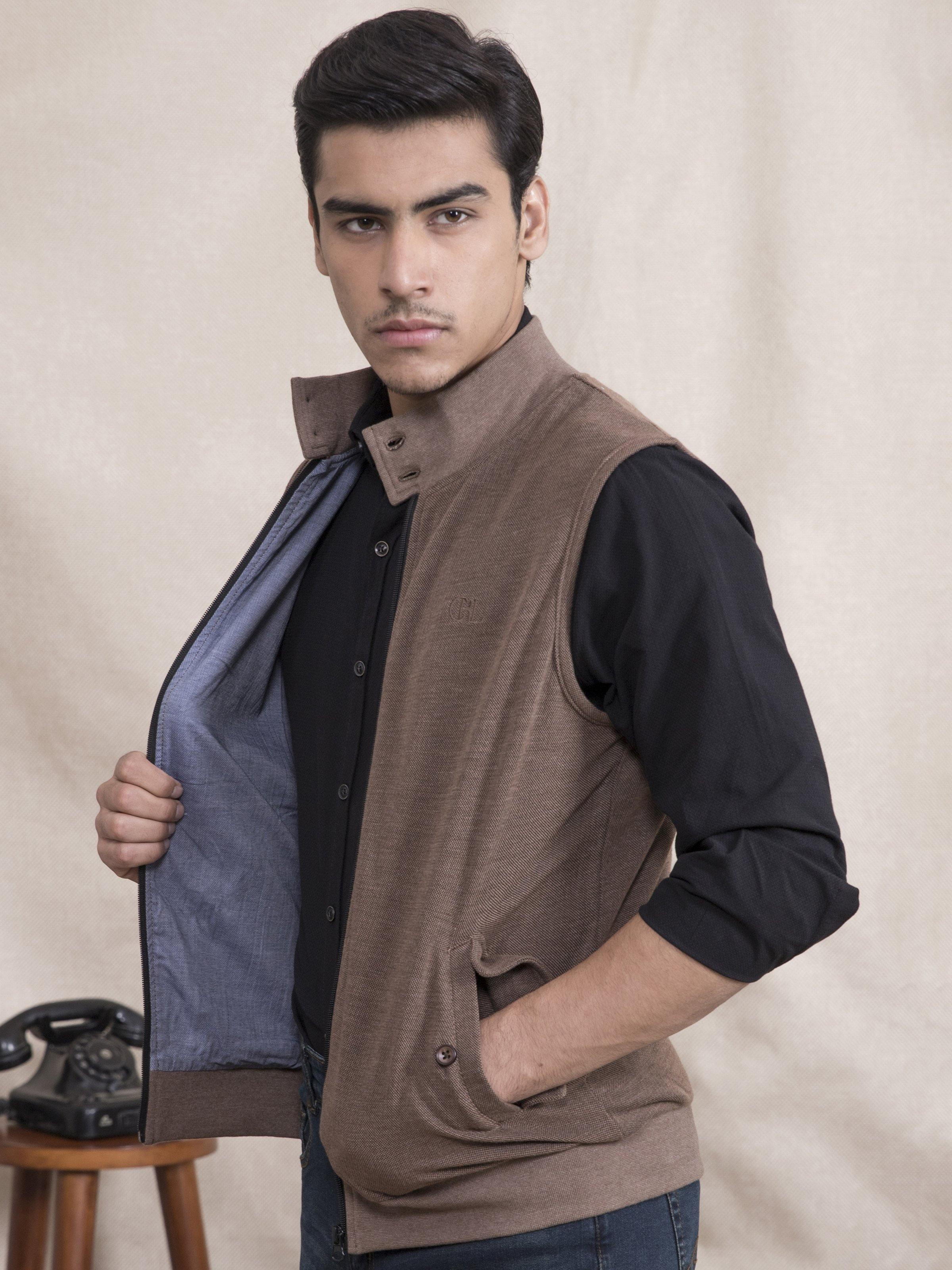 Brown sleeveless jacket with front zipper and mock-neck collar detail