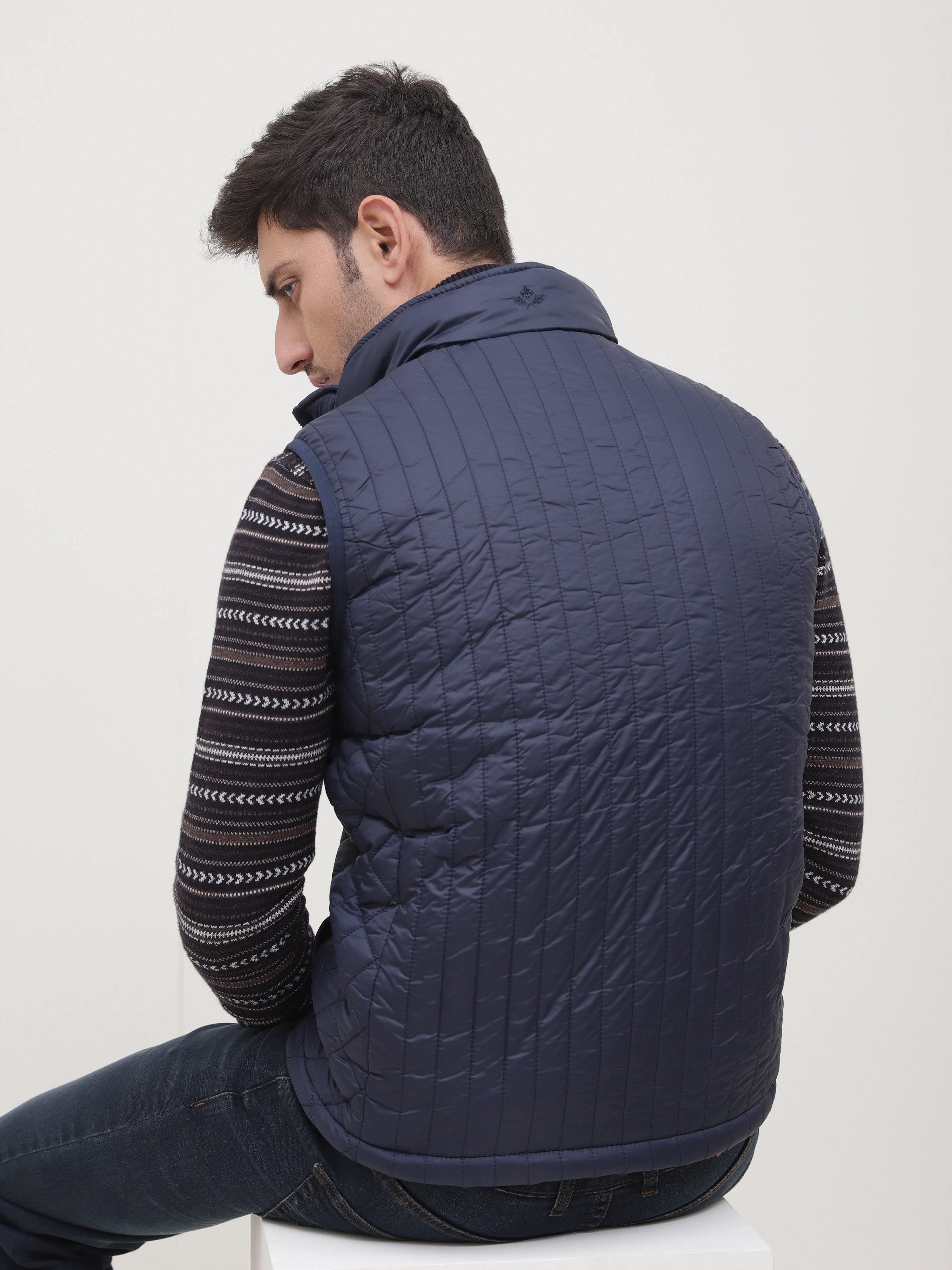 Navy sleeveless quilted jacket back view with horizontal stitching