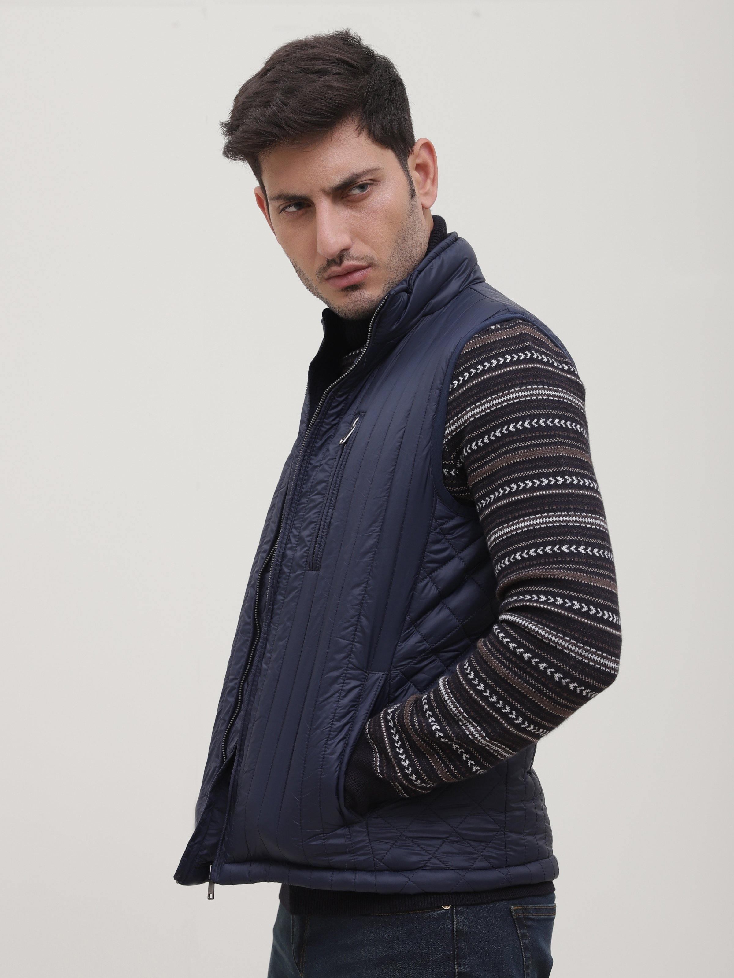 Navy sleeveless quilted jacket with zipper closure and stand collar, side view