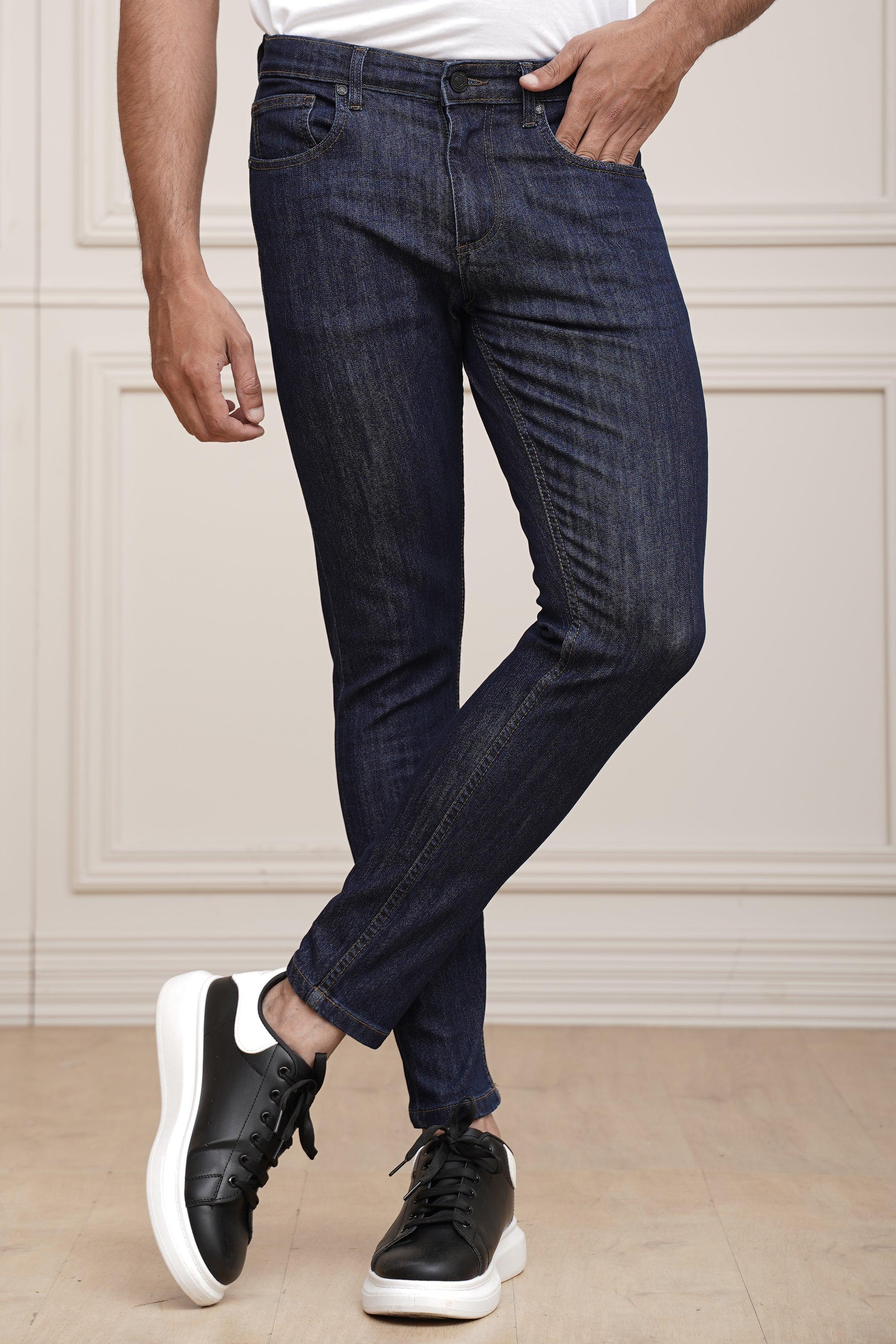 Navy blue slim jeans with tapered leg, five pockets, and belt loops